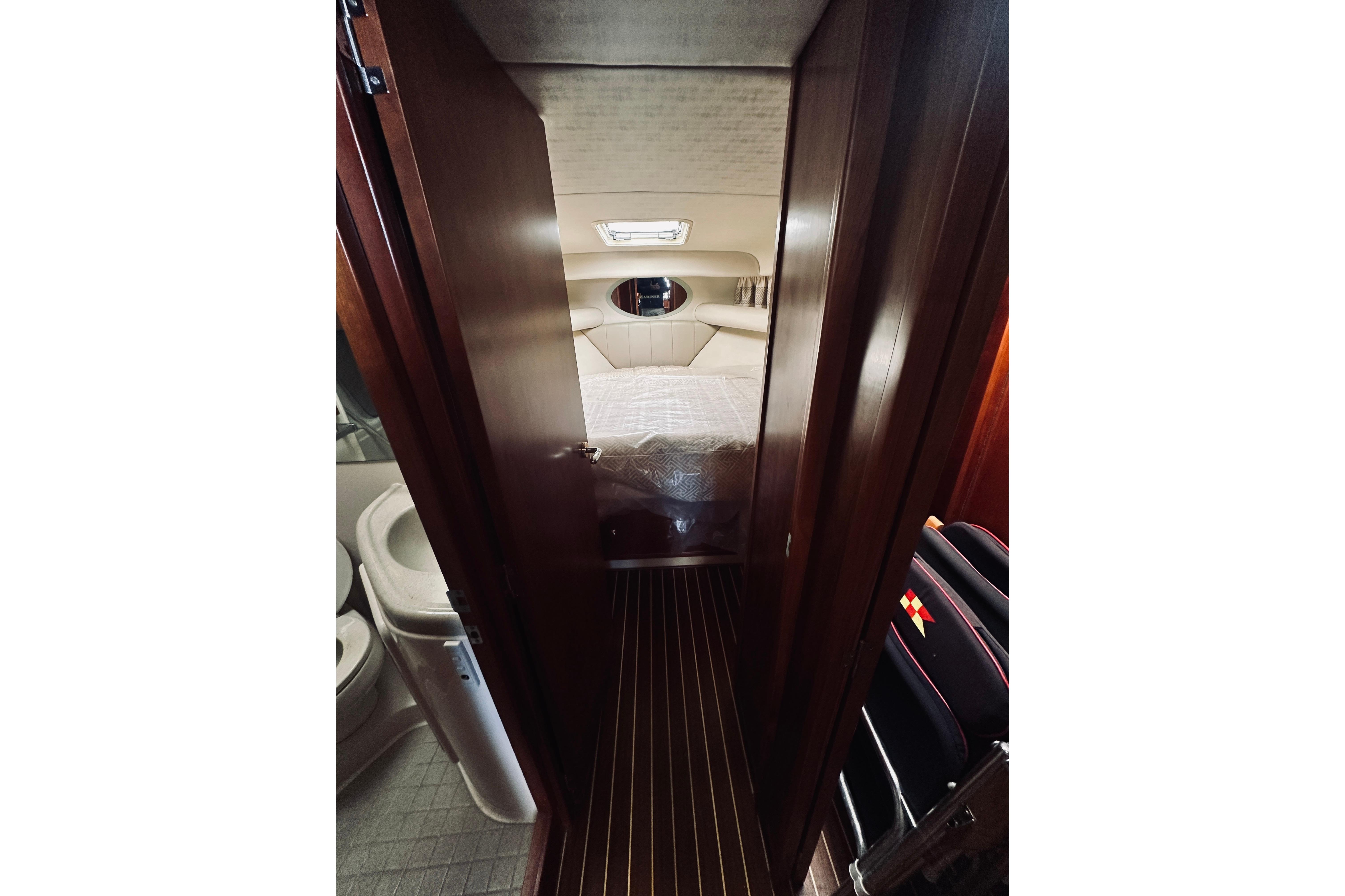 Interior view of 2000 Riviera 40 yacht cabin with bed and bathroom.