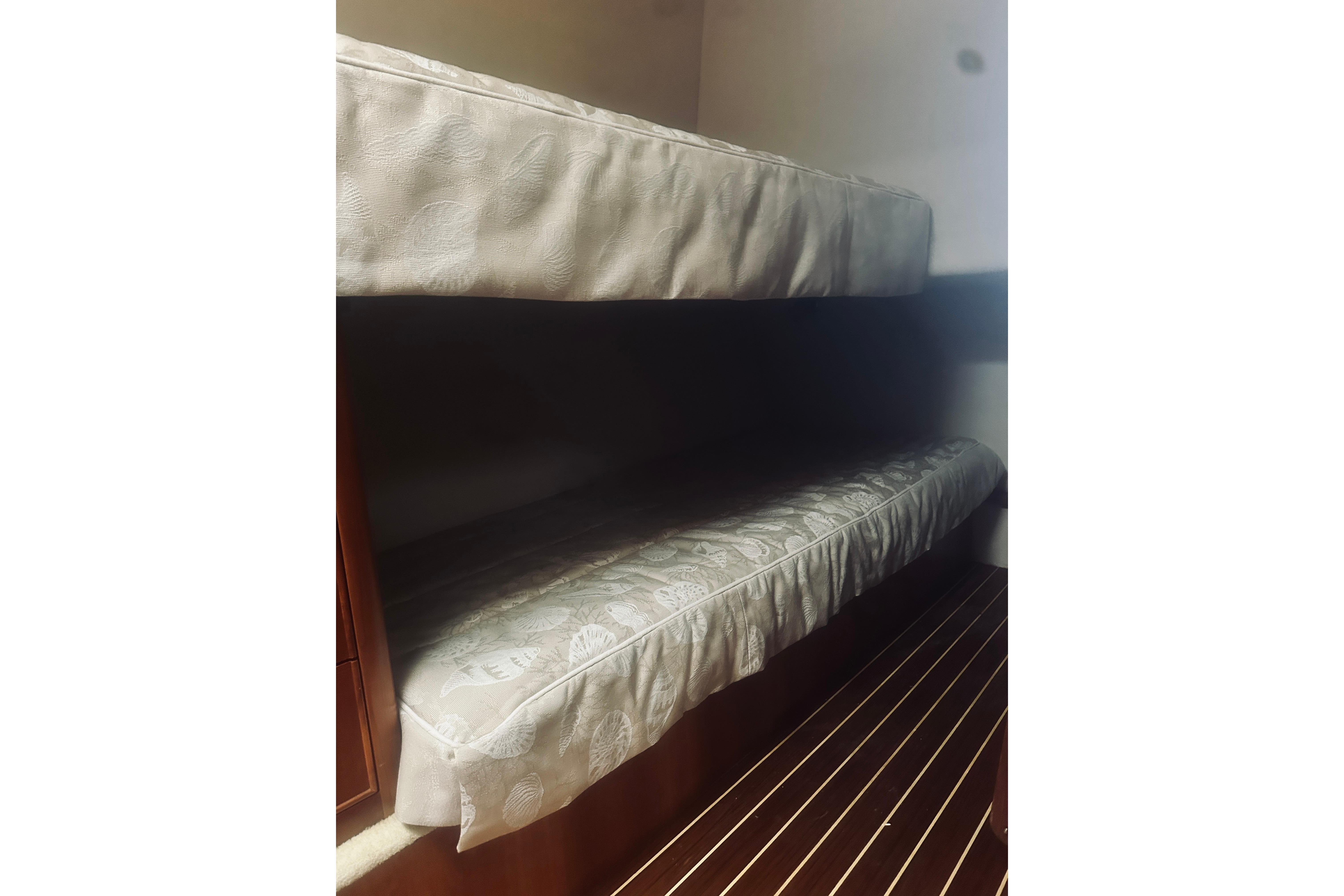 Bunk beds in 2000 Riviera 40 yacht interior with patterned bedding.