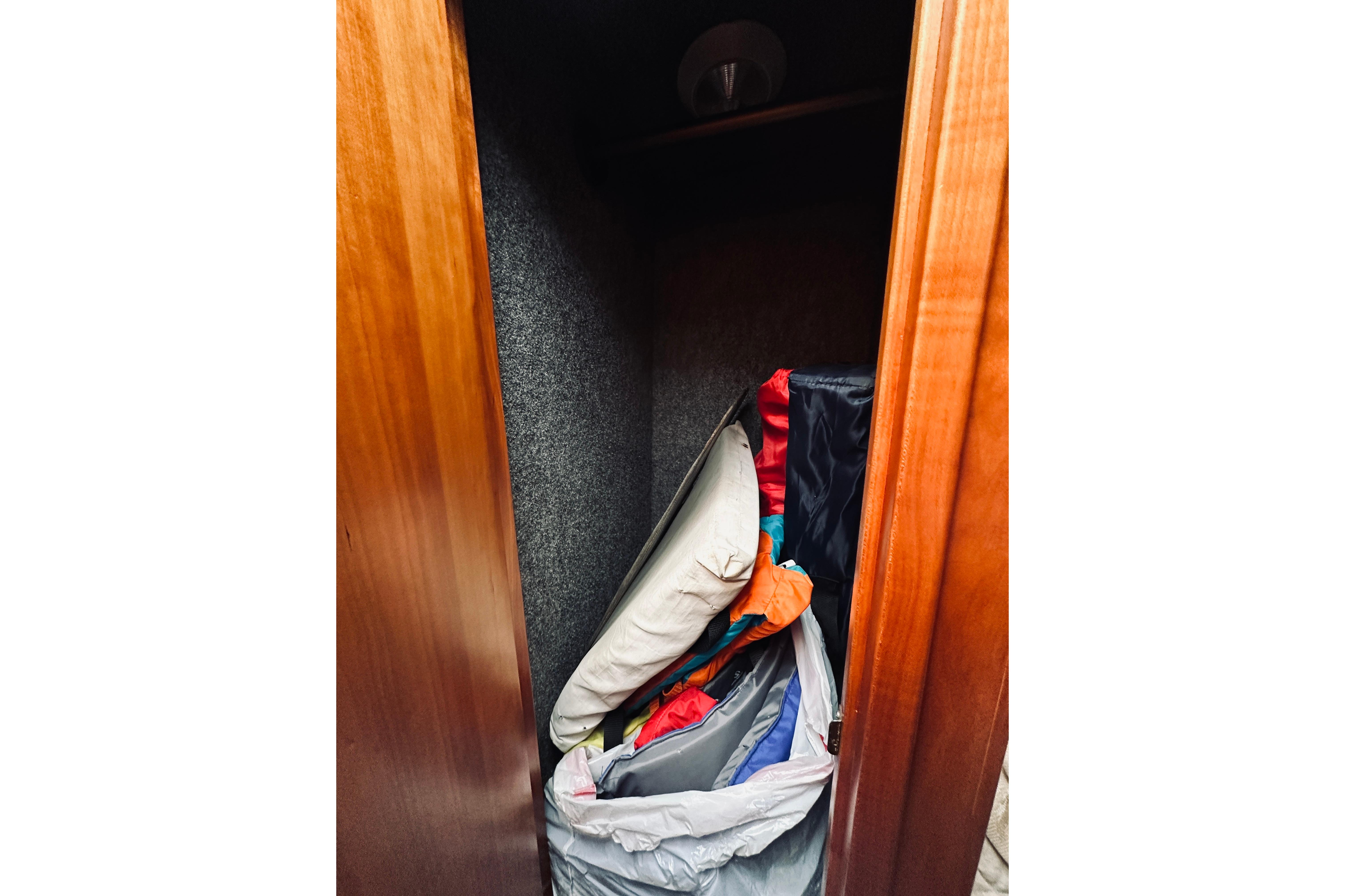 Storage compartment in 2000 Riviera 40 boat with cushions and bags.