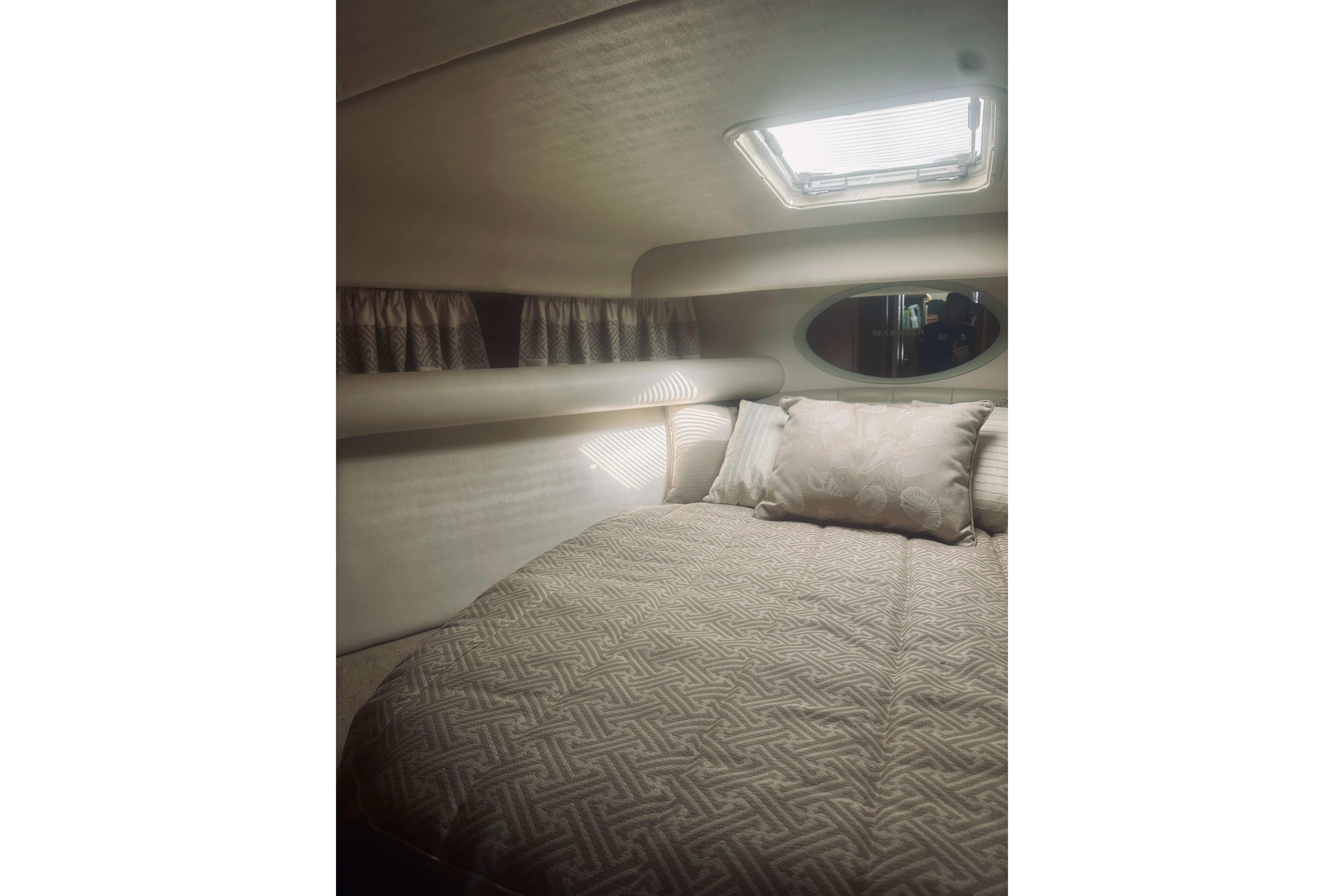 Interior cabin of 2000 Riviera 40 yacht with bed and window.