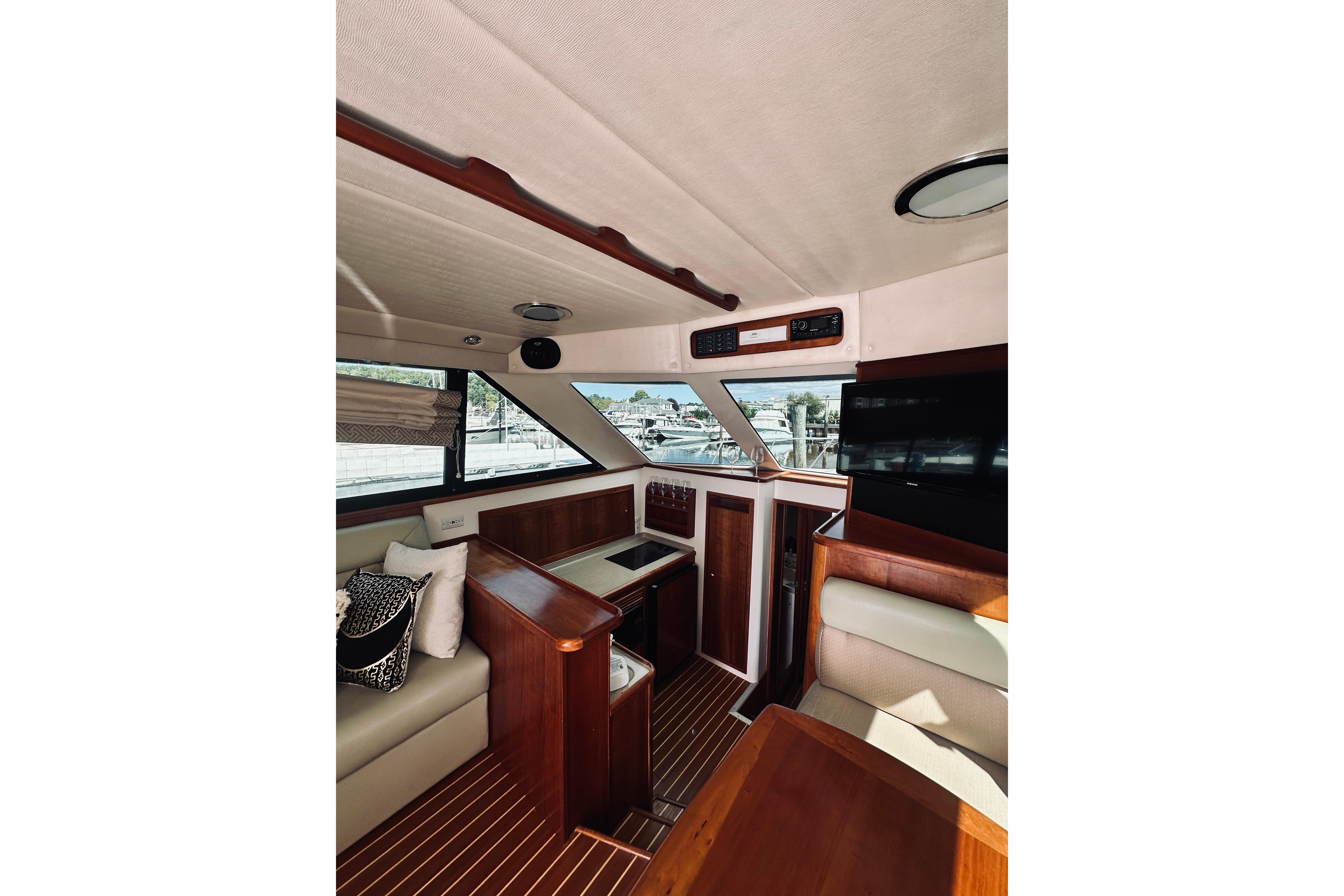 Interior of a 2000 Riviera 40 yacht with elegant wood finishes and comfortable seating.