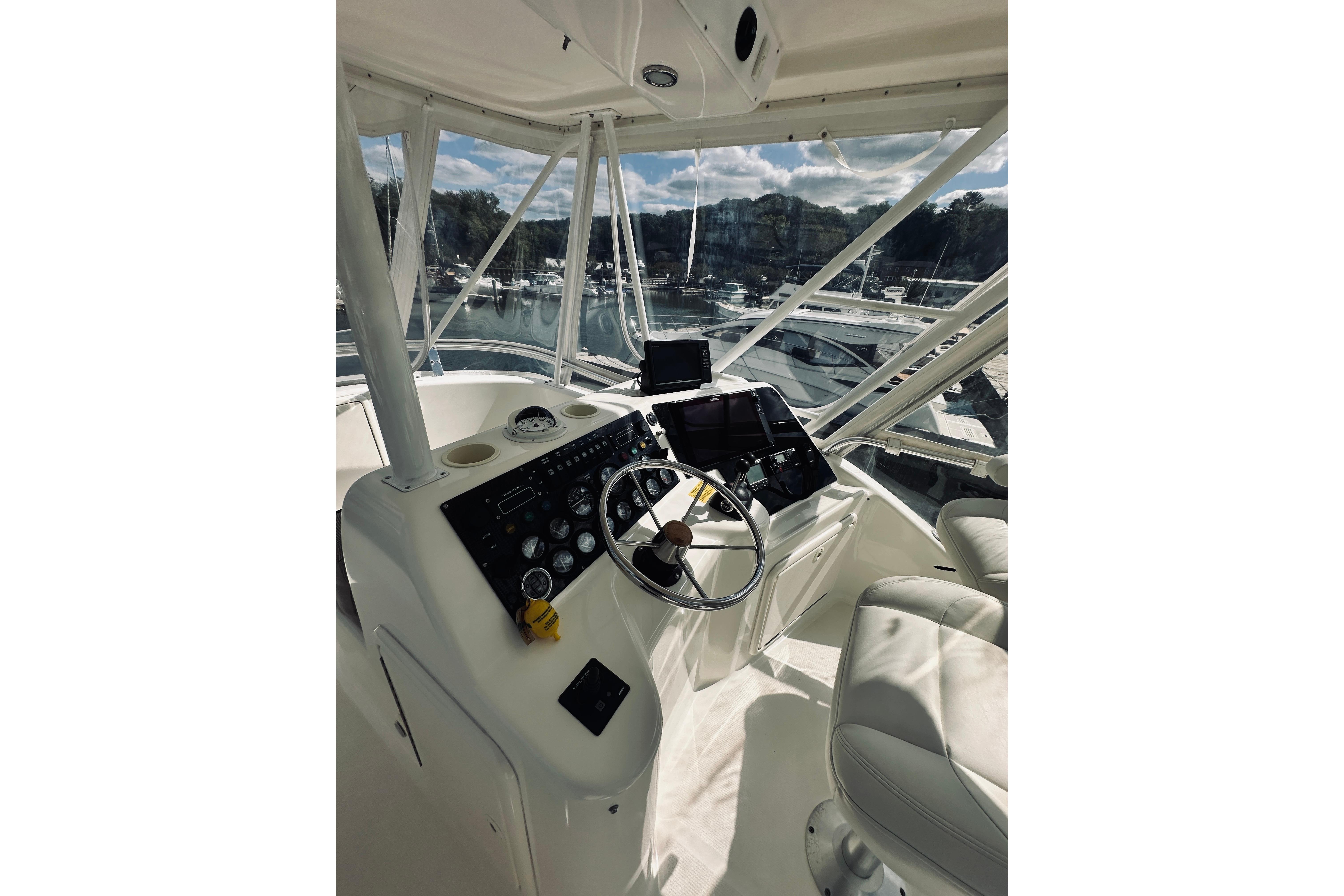 Helm of 2000 Riviera 40 yacht with steering wheel and navigation equipment.