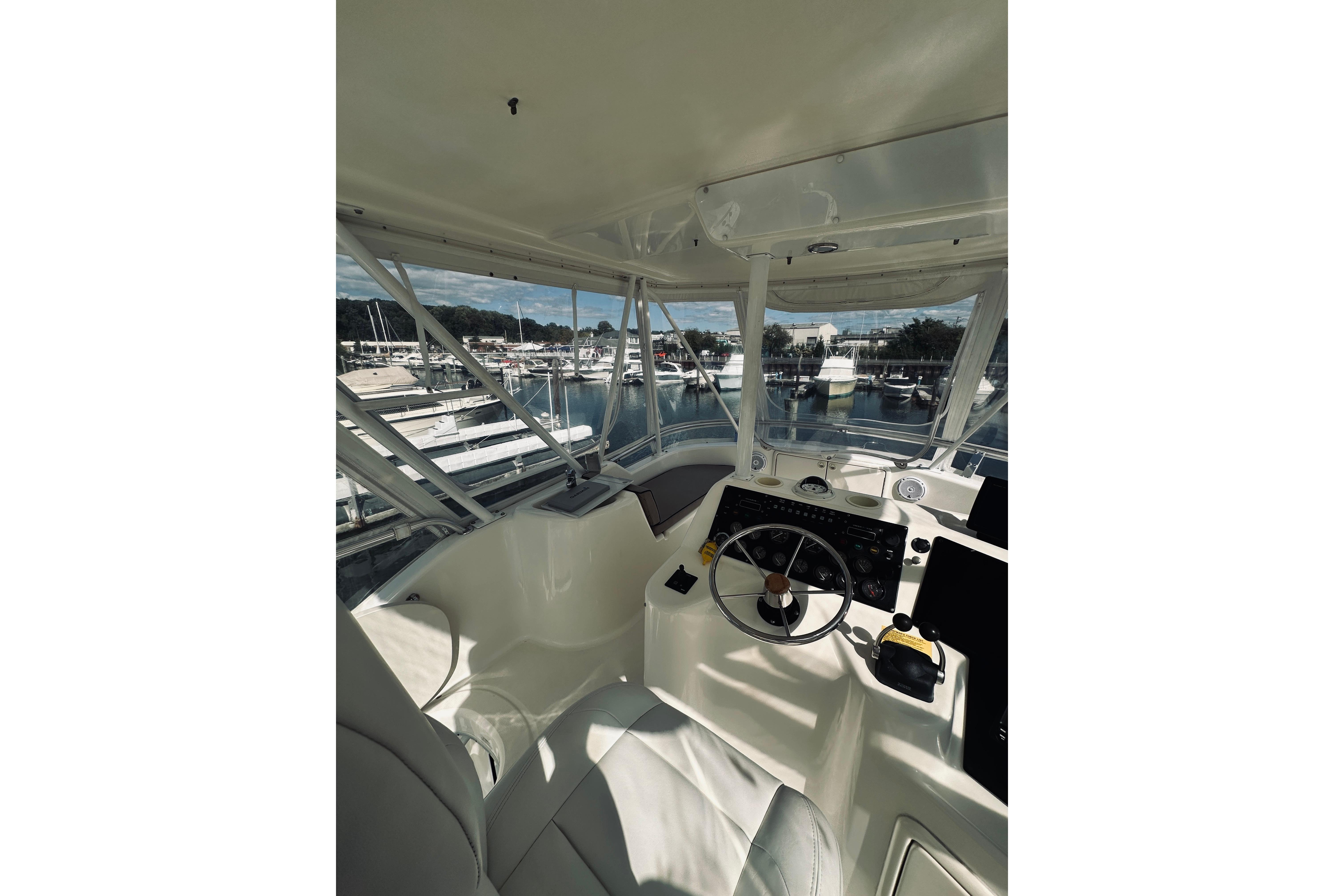 Interior view of 2000 Riviera 40 yacht cockpit with marina background.