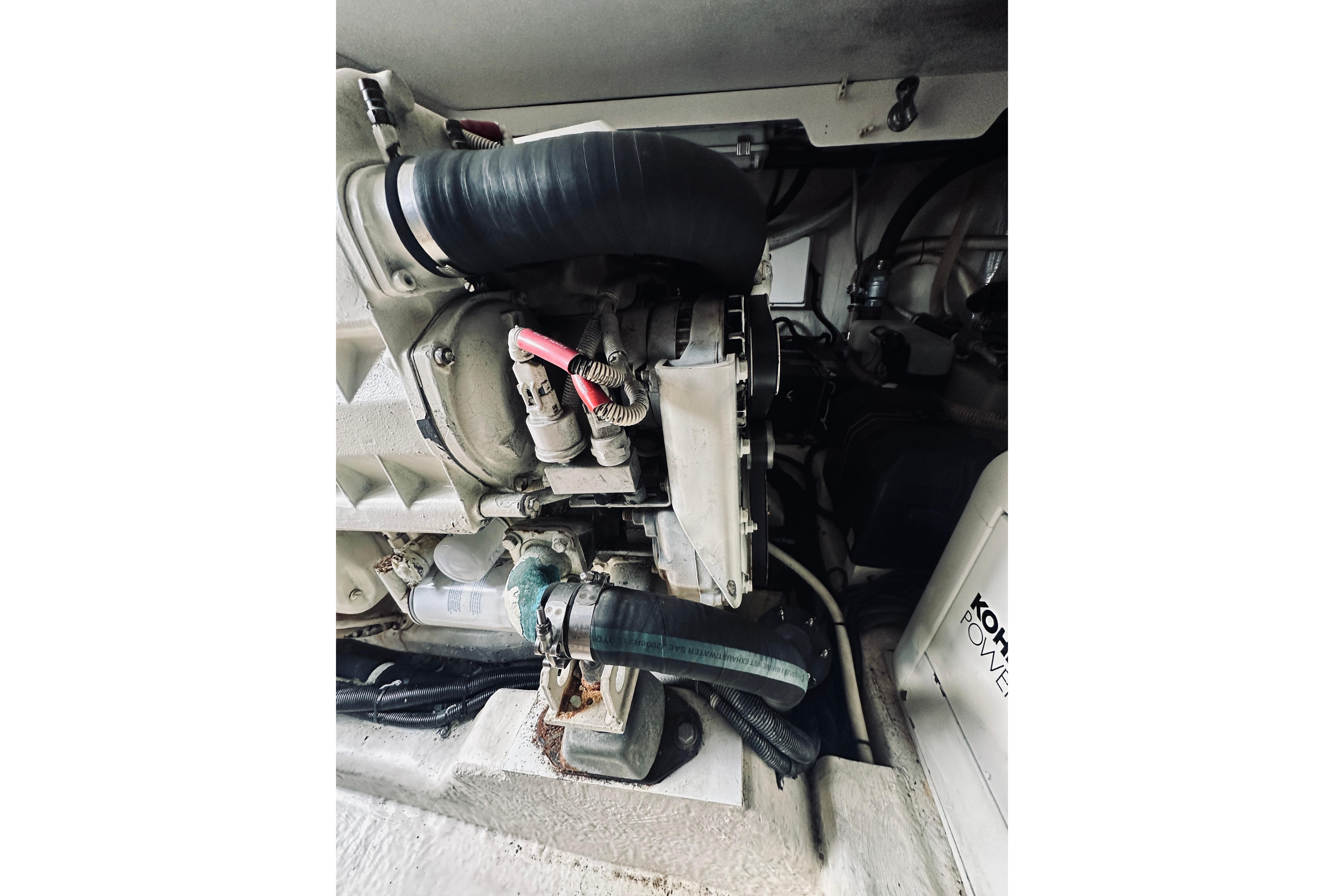 Engine compartment of a 2000 Riviera 40 boat, featuring mechanical components and hoses.