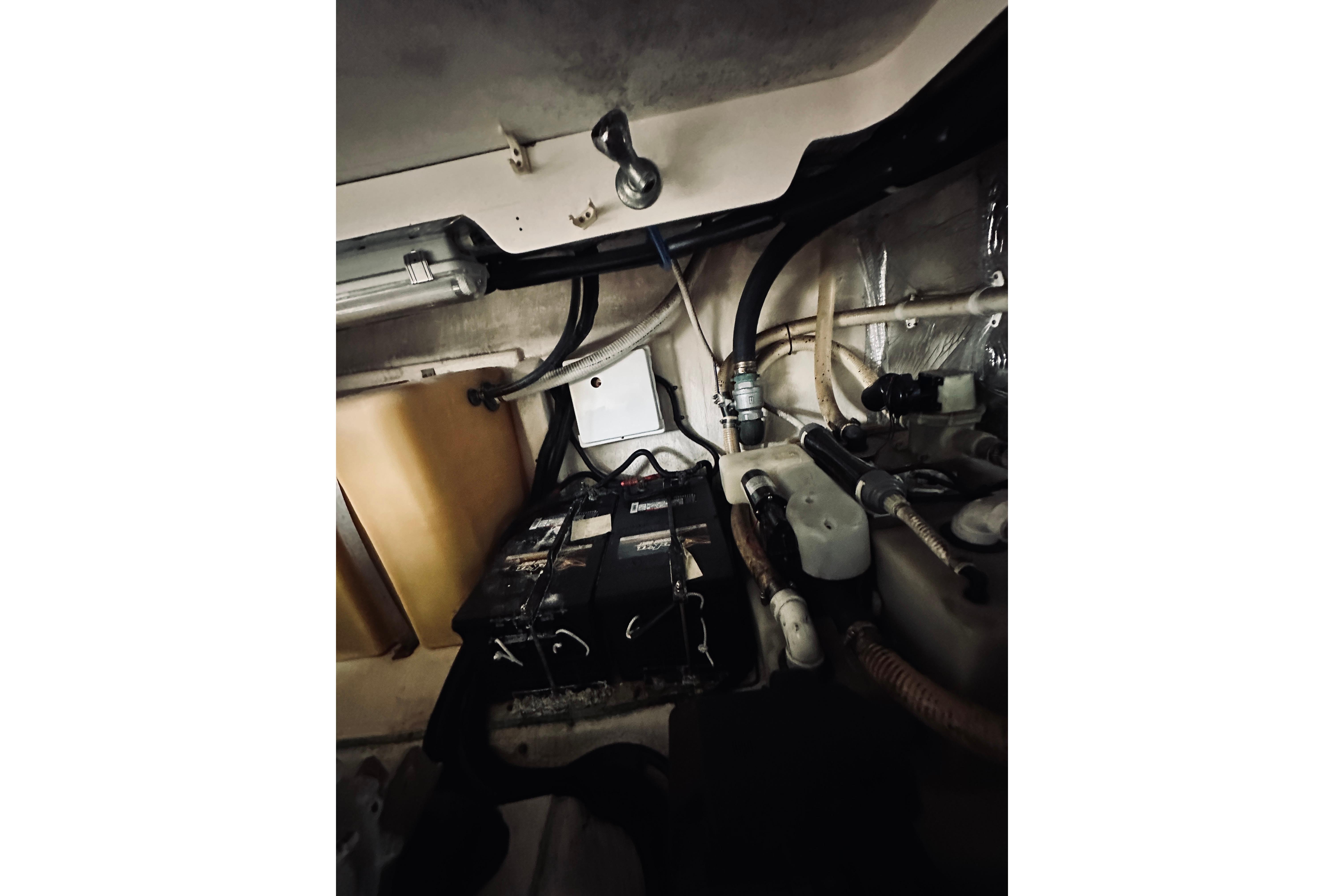 Engine room of a 2000 Riviera 40 boat, featuring batteries and wiring.