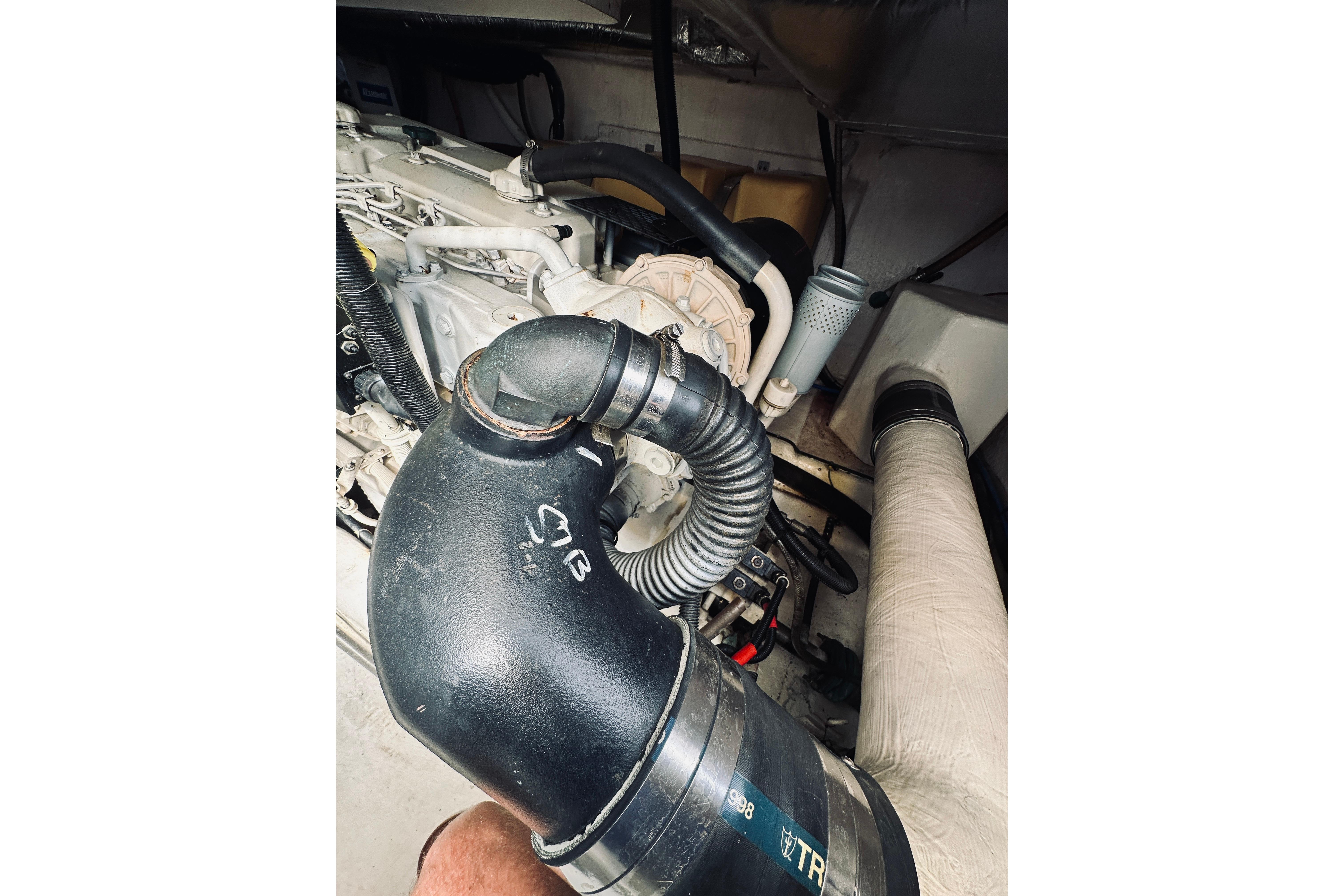 Engine compartment of a 2000 Riviera 40 boat, featuring hoses and components.