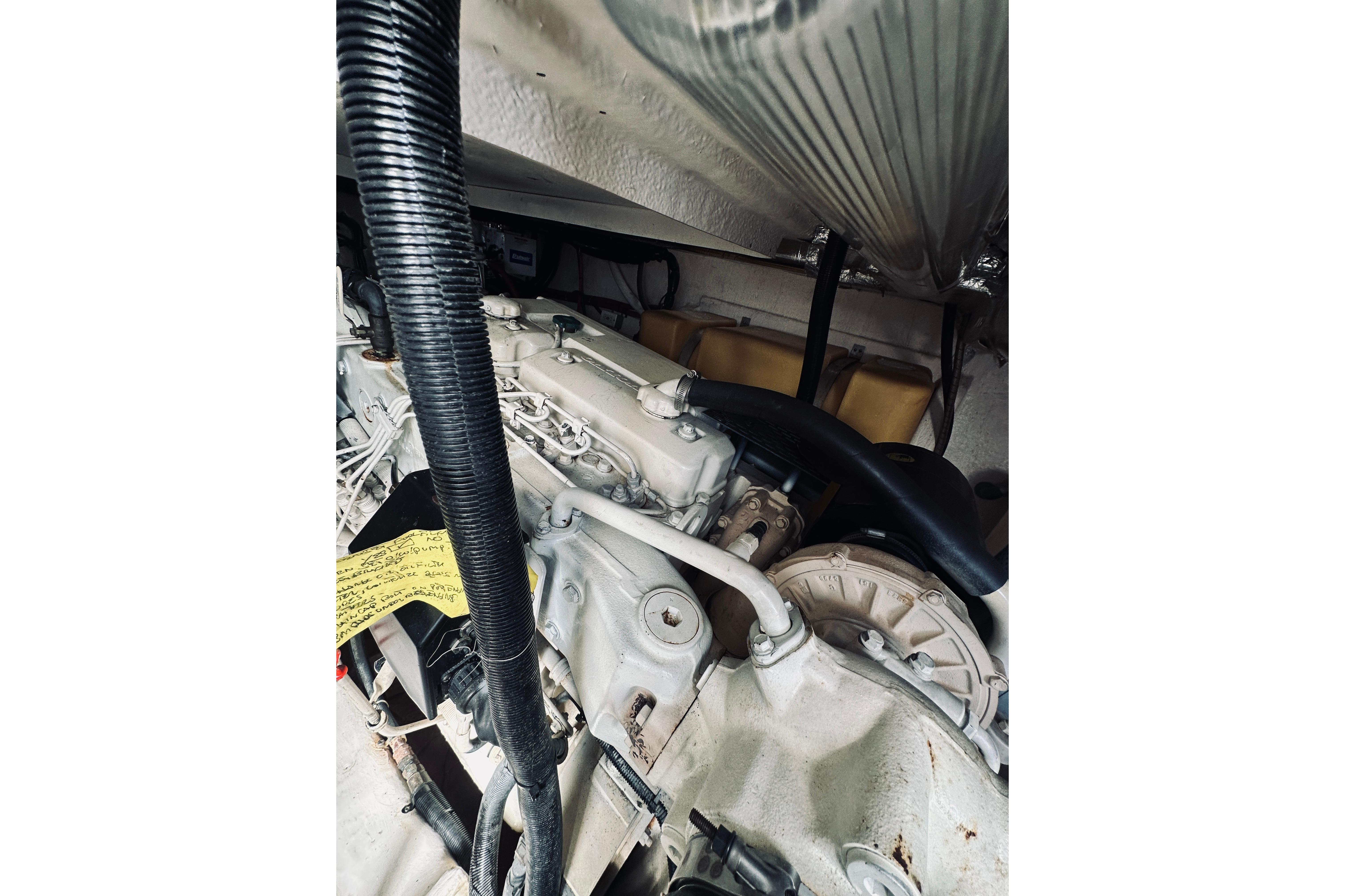 Engine compartment of a 2000 Riviera 40 boat, showcasing mechanical components and hoses.