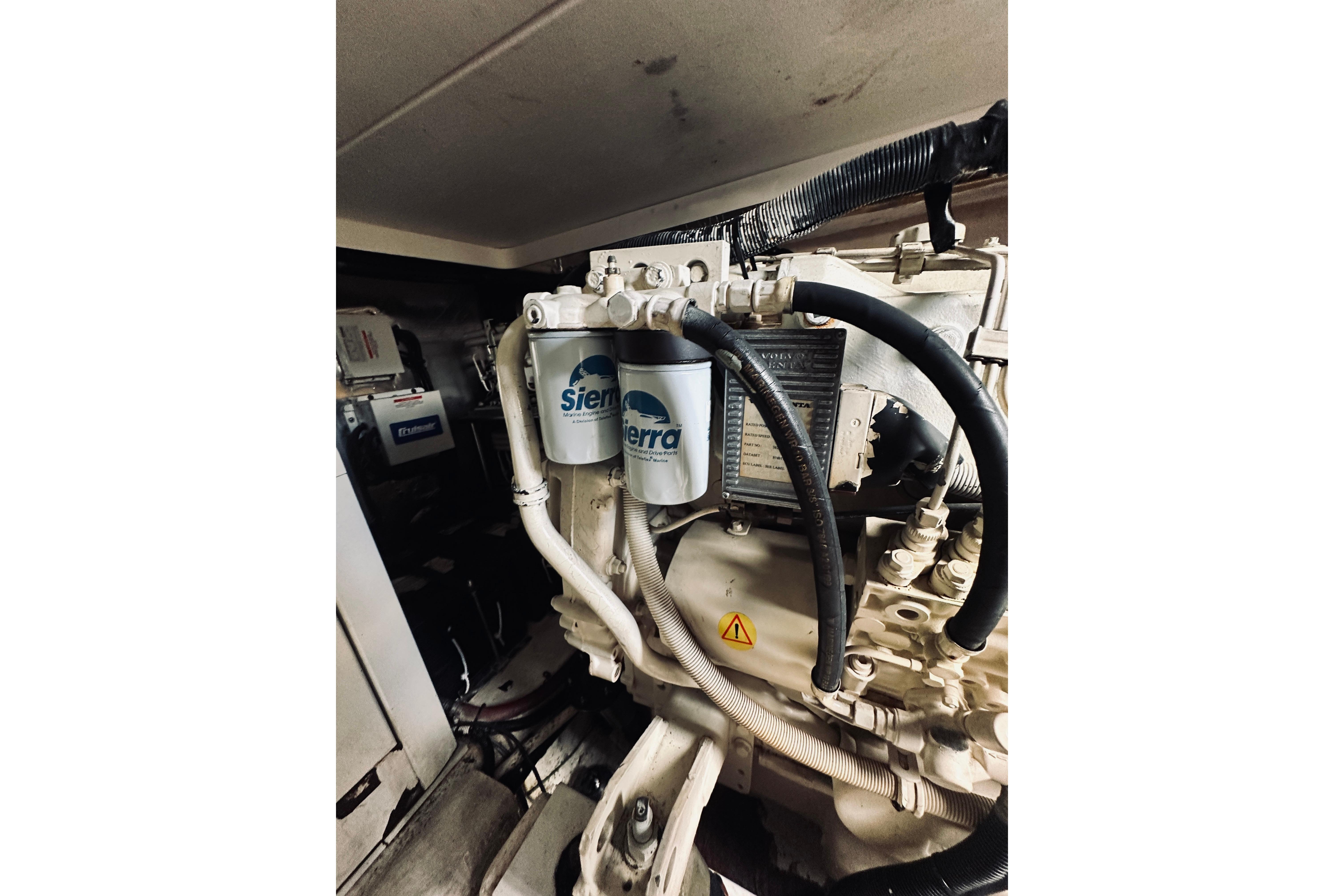 Engine compartment of a 2000 Riviera 40 boat with Sierra filters and hoses.