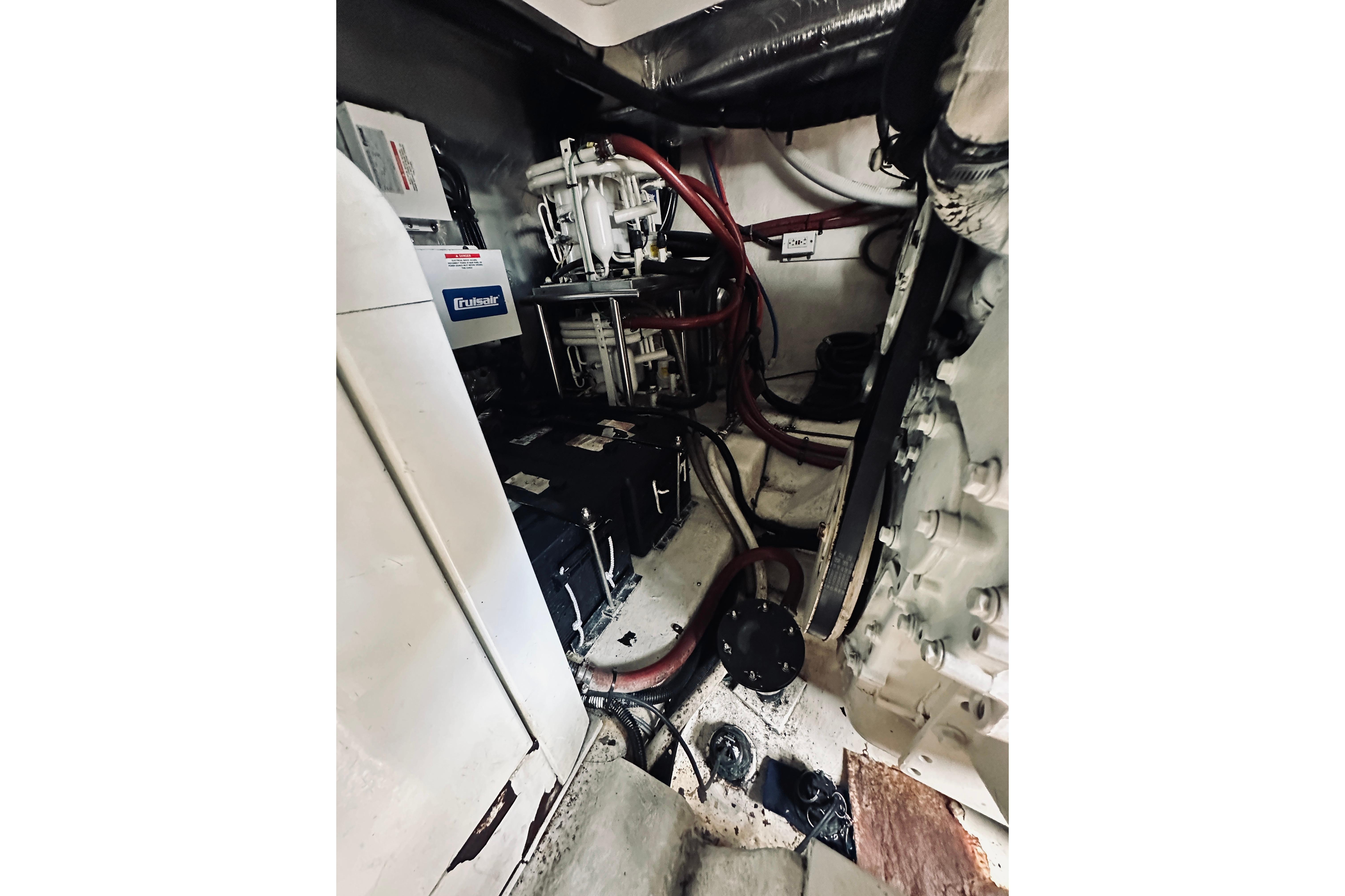 Engine room of 2000 Riviera 40 boat with mechanical components and wiring.