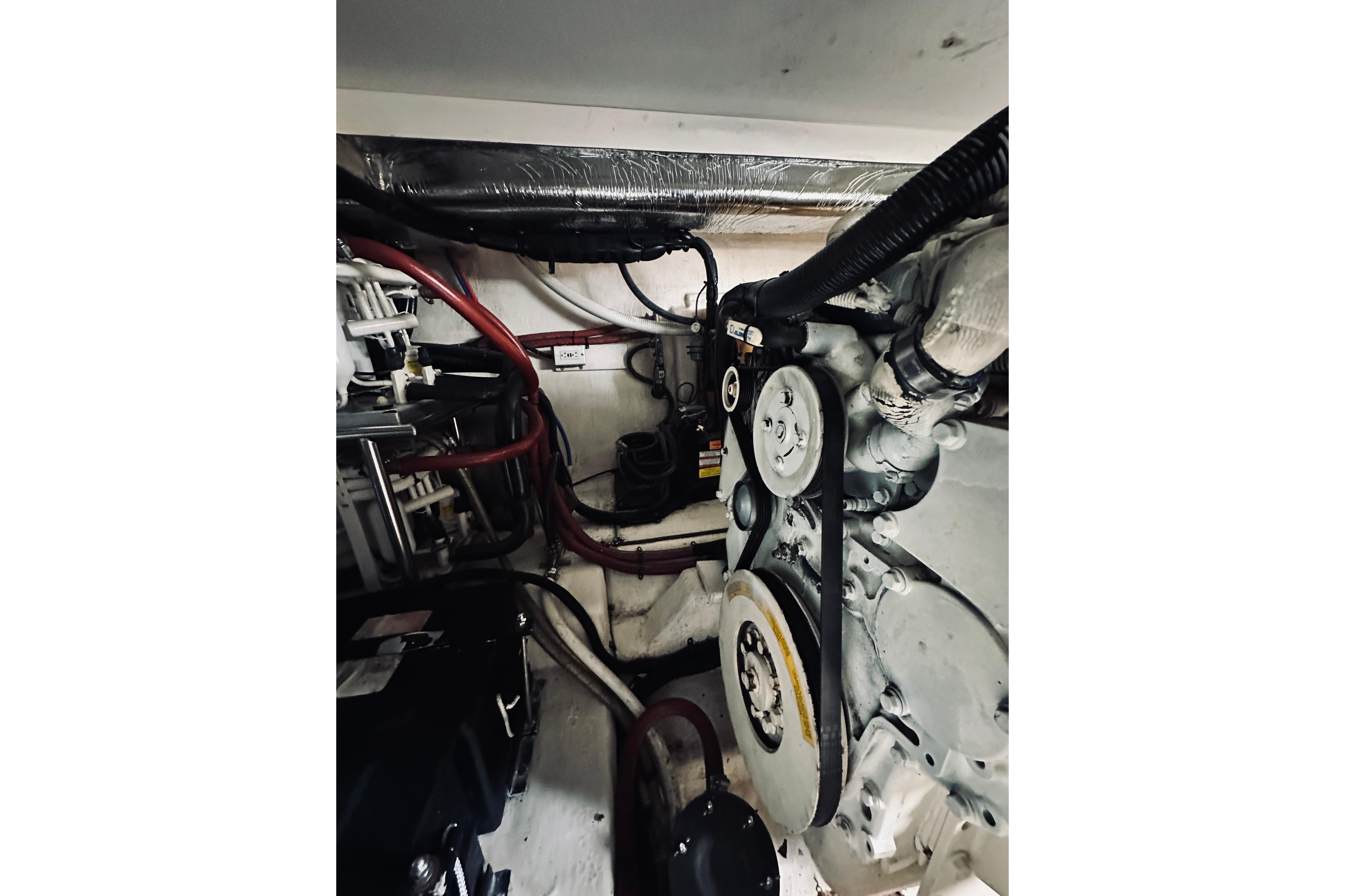 Engine room of a 2000 Riviera 40 boat, showcasing mechanical components and wiring.