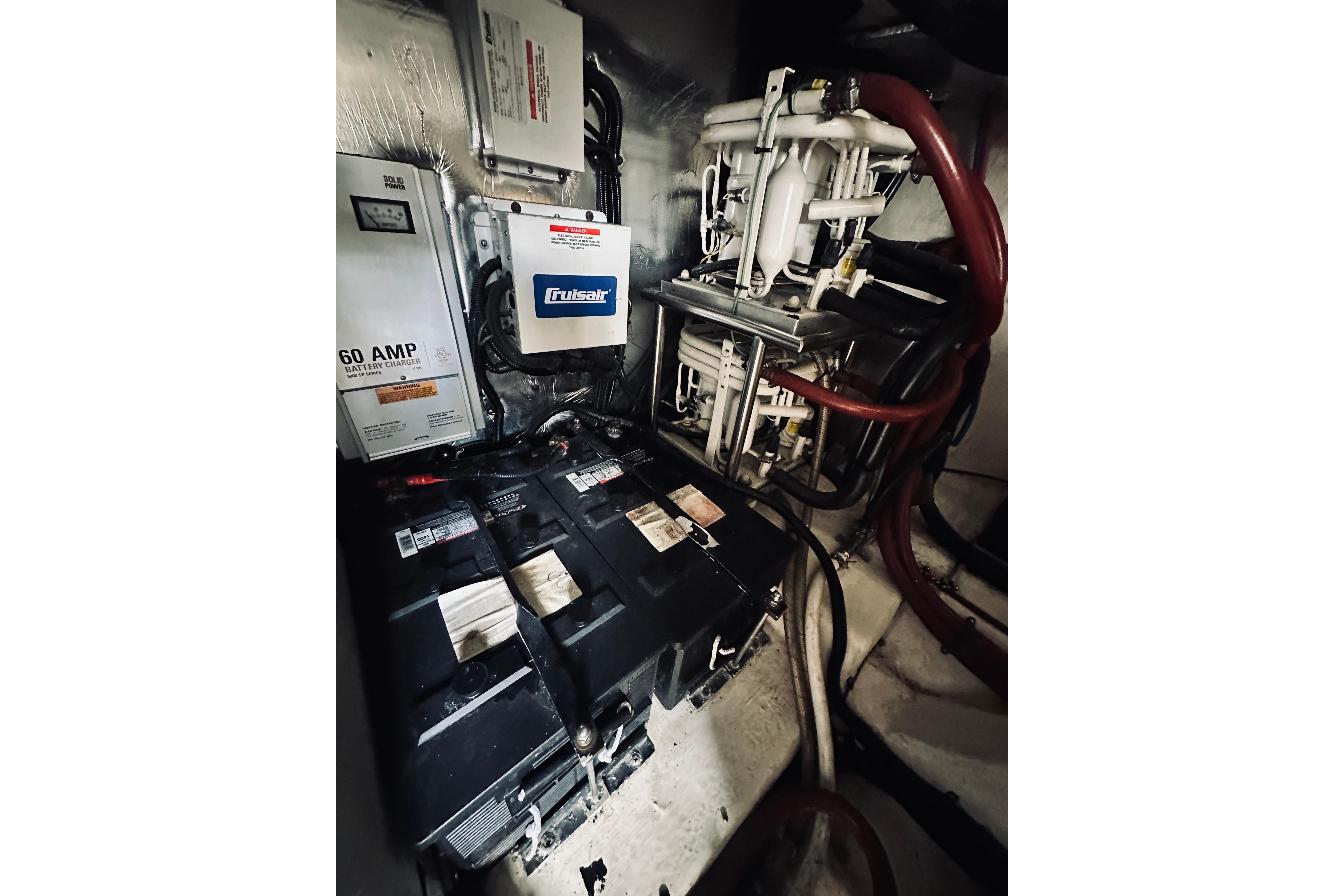 Engine room of 2000 Riviera 40 with batteries and electrical components.