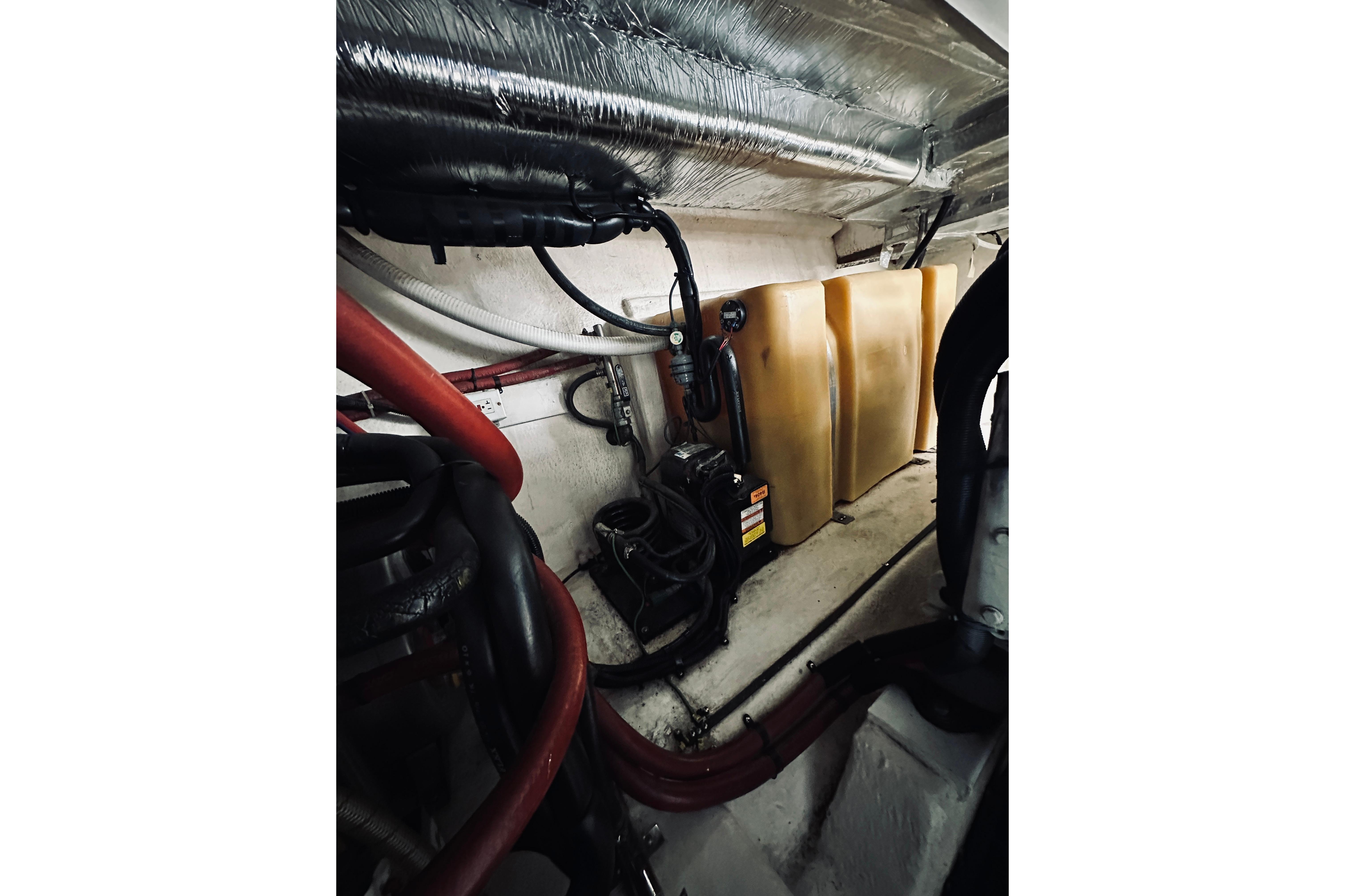 Engine room of 2000 Riviera 40 boat with pipes and equipment.