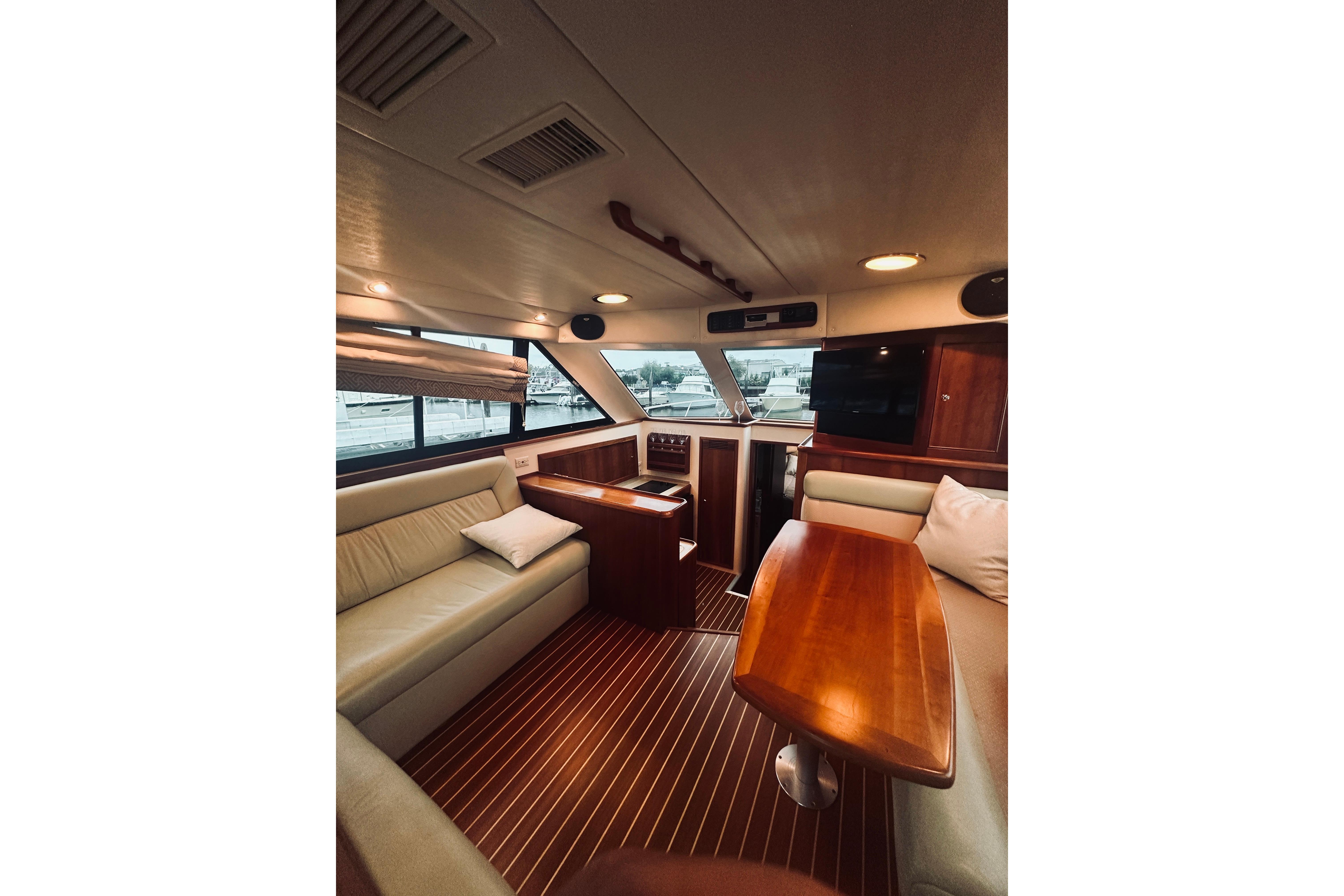 Luxurious interior of a 2000 Riviera 40 yacht with elegant wood finishes and comfortable seating.