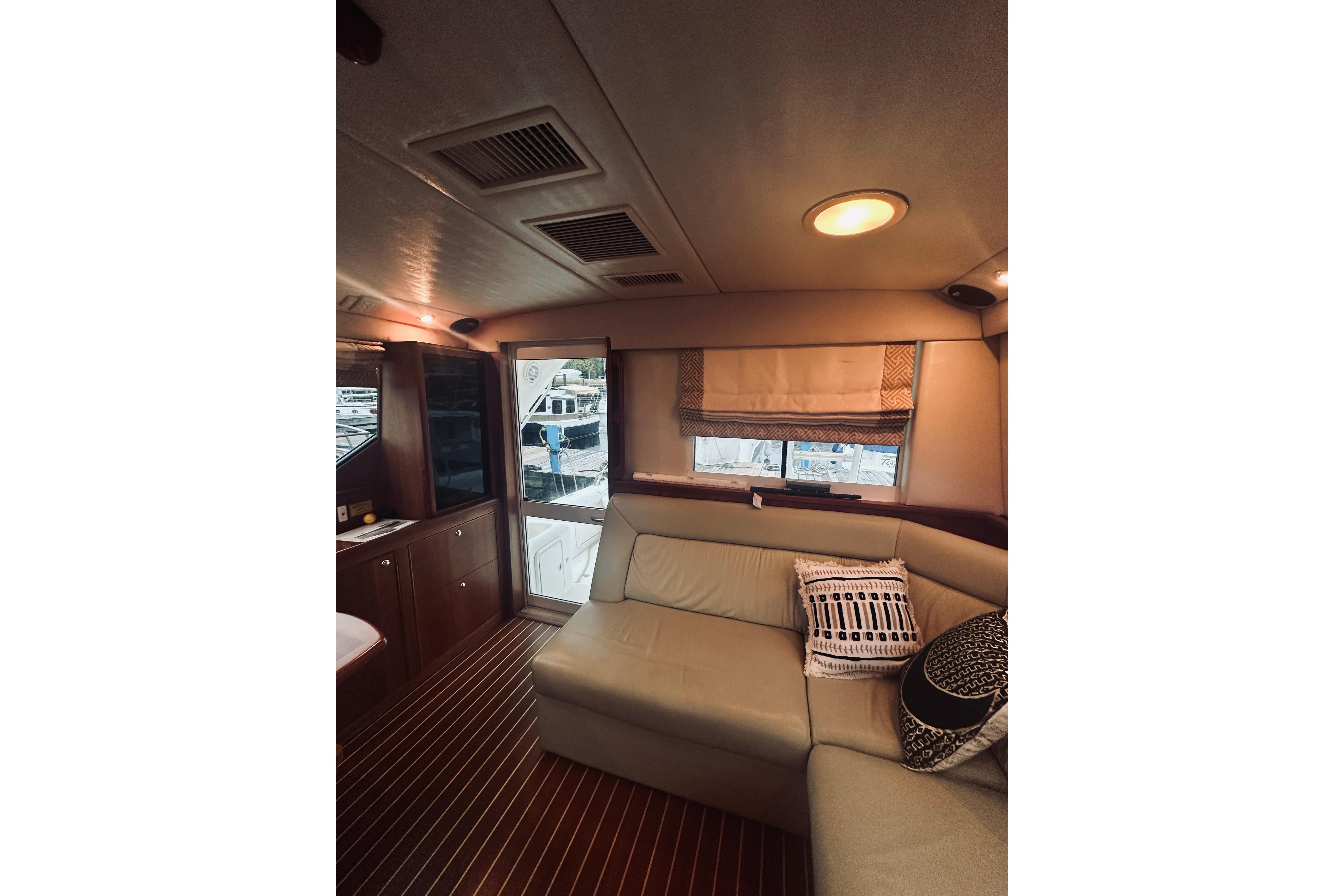 Interior of 2000 Riviera 40 yacht with cozy seating and elegant decor.