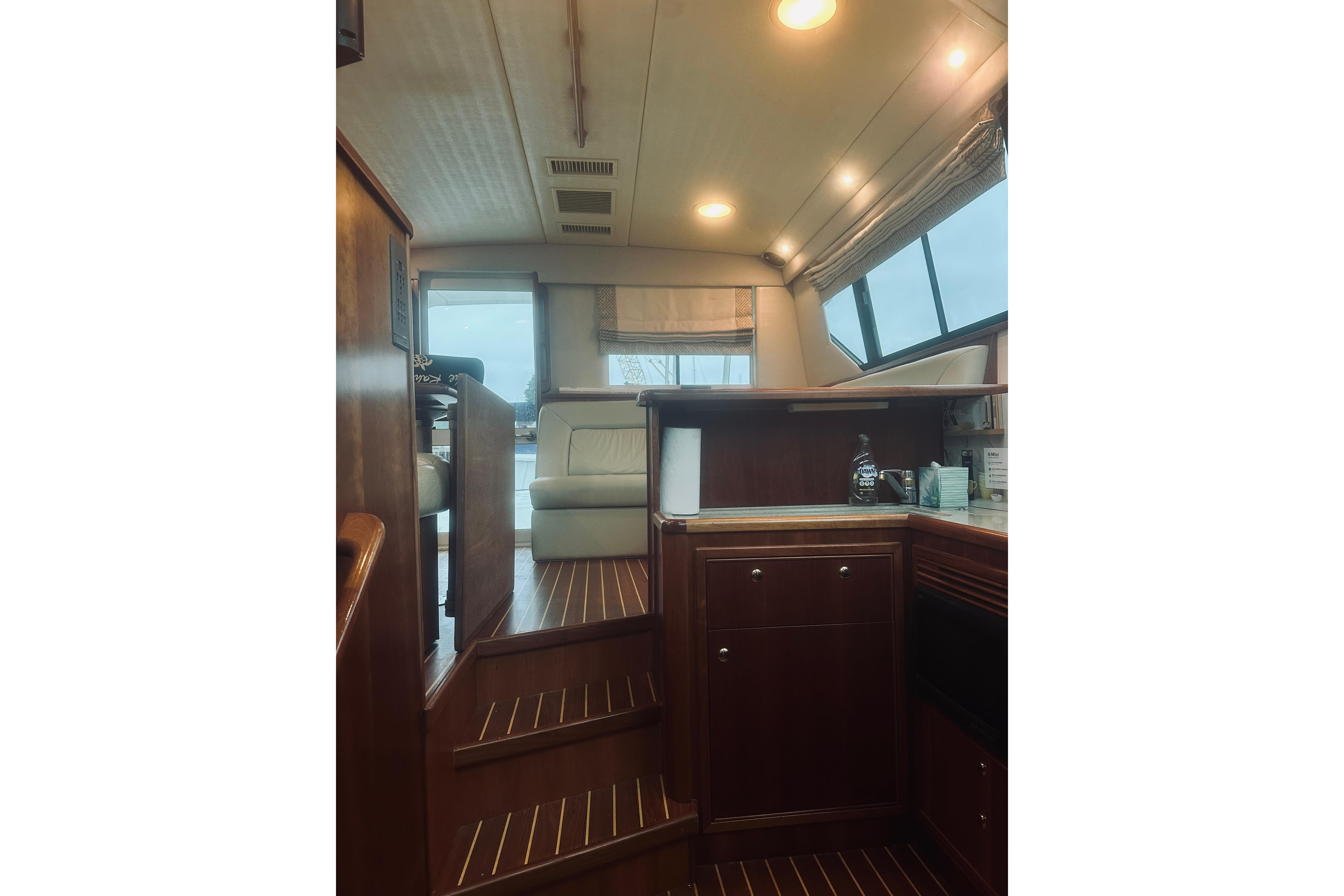 Interior of 2000 Riviera 40 yacht with wooden cabinetry and seating area.