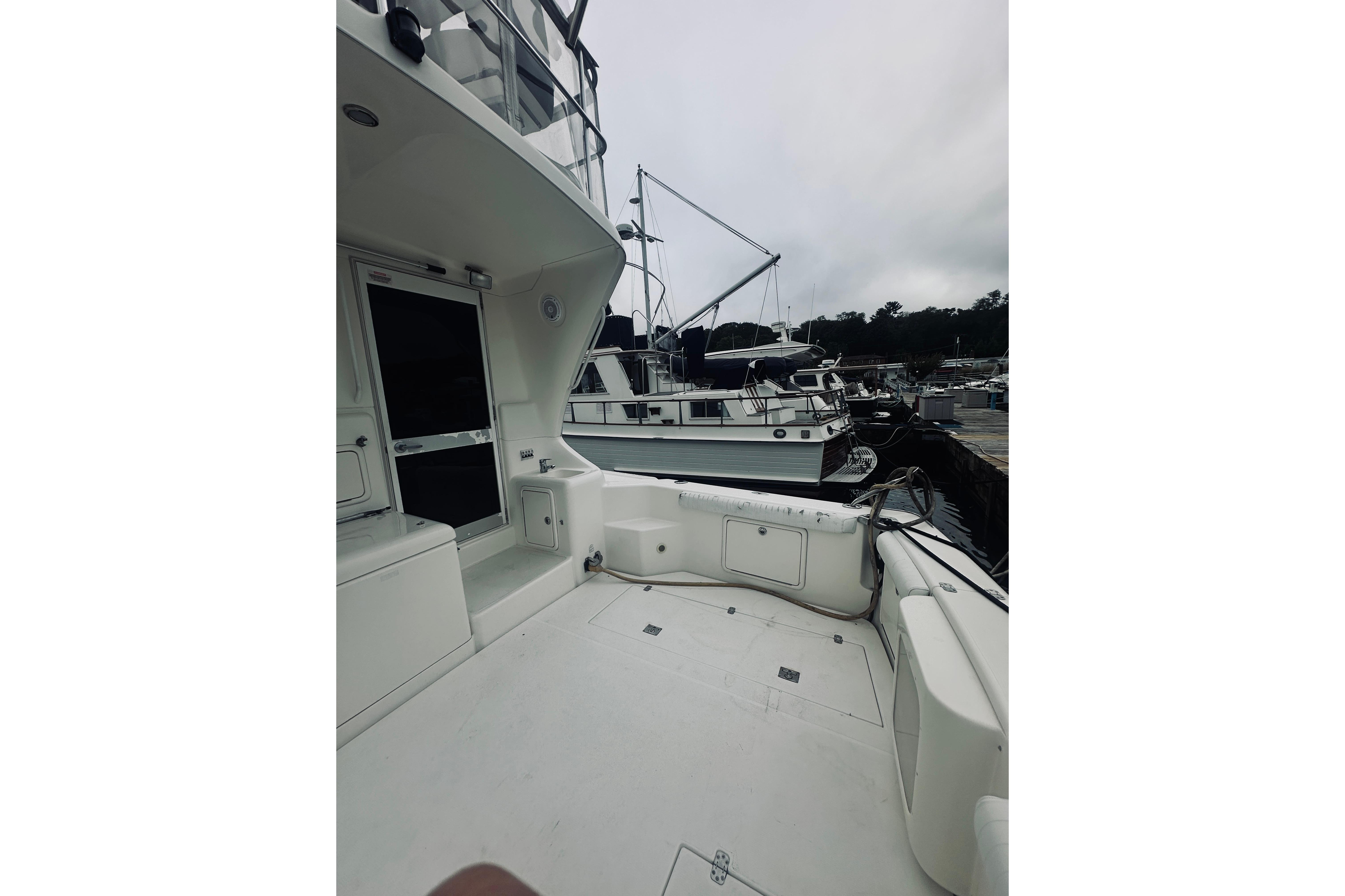 2000 Riviera 40 yacht docked at marina, featuring spacious deck and sleek design.