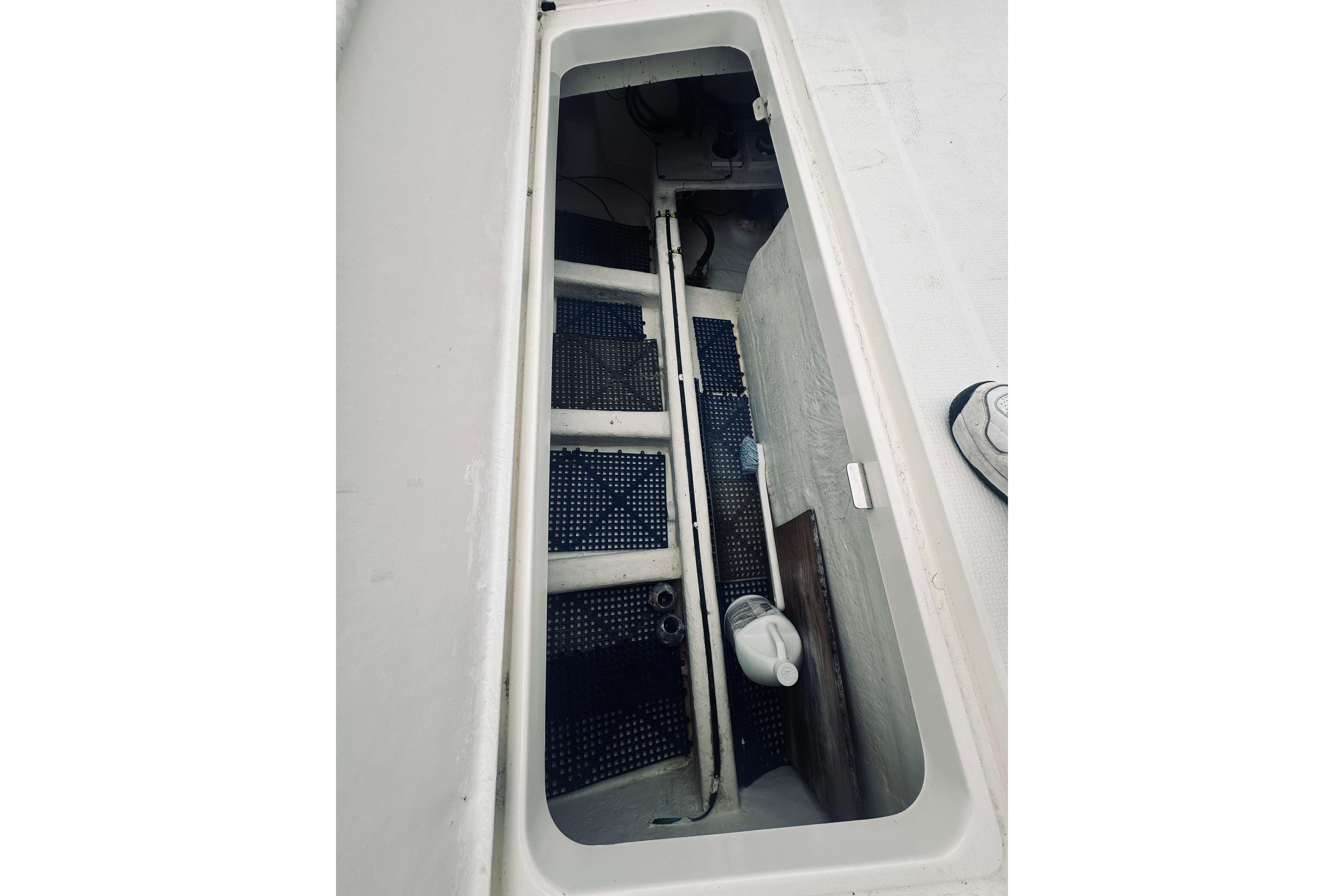 Open storage compartment on 2000 Riviera 40 boat deck, showing interior details.