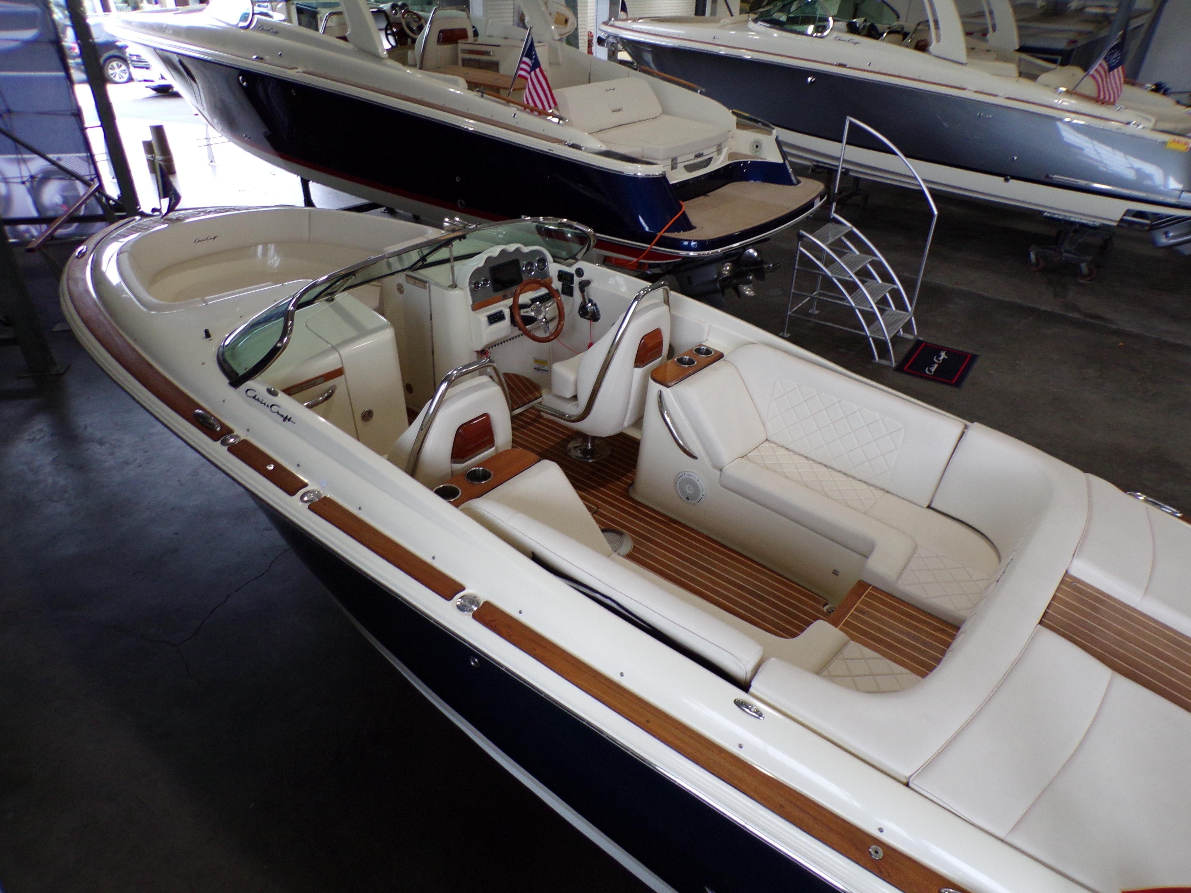 2021 Chris-Craft Launch 27 boat with luxurious interior in a showroom.