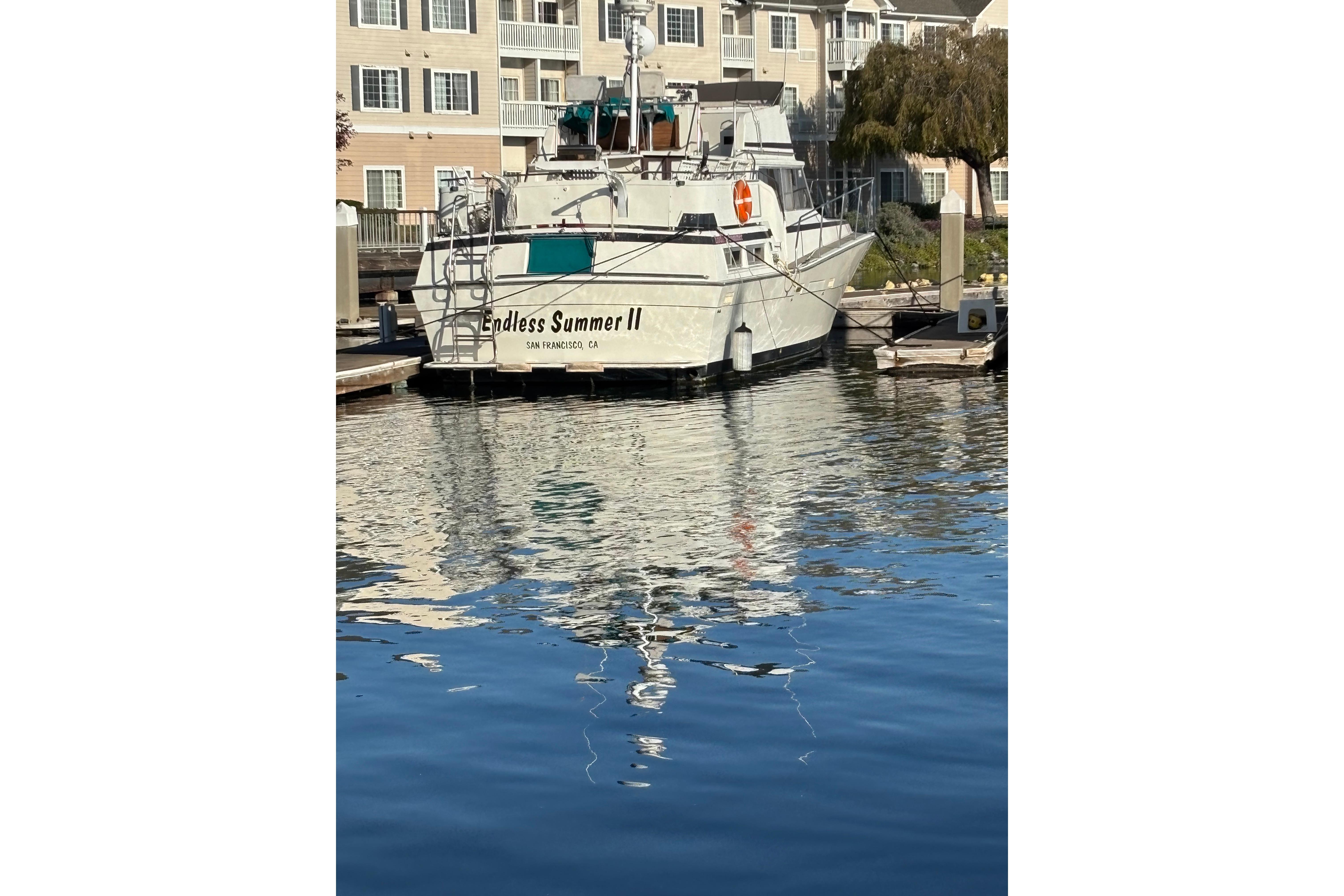 1979 Viking 43 boat "Endless Summer II" docked in a marina, reflecting on water.