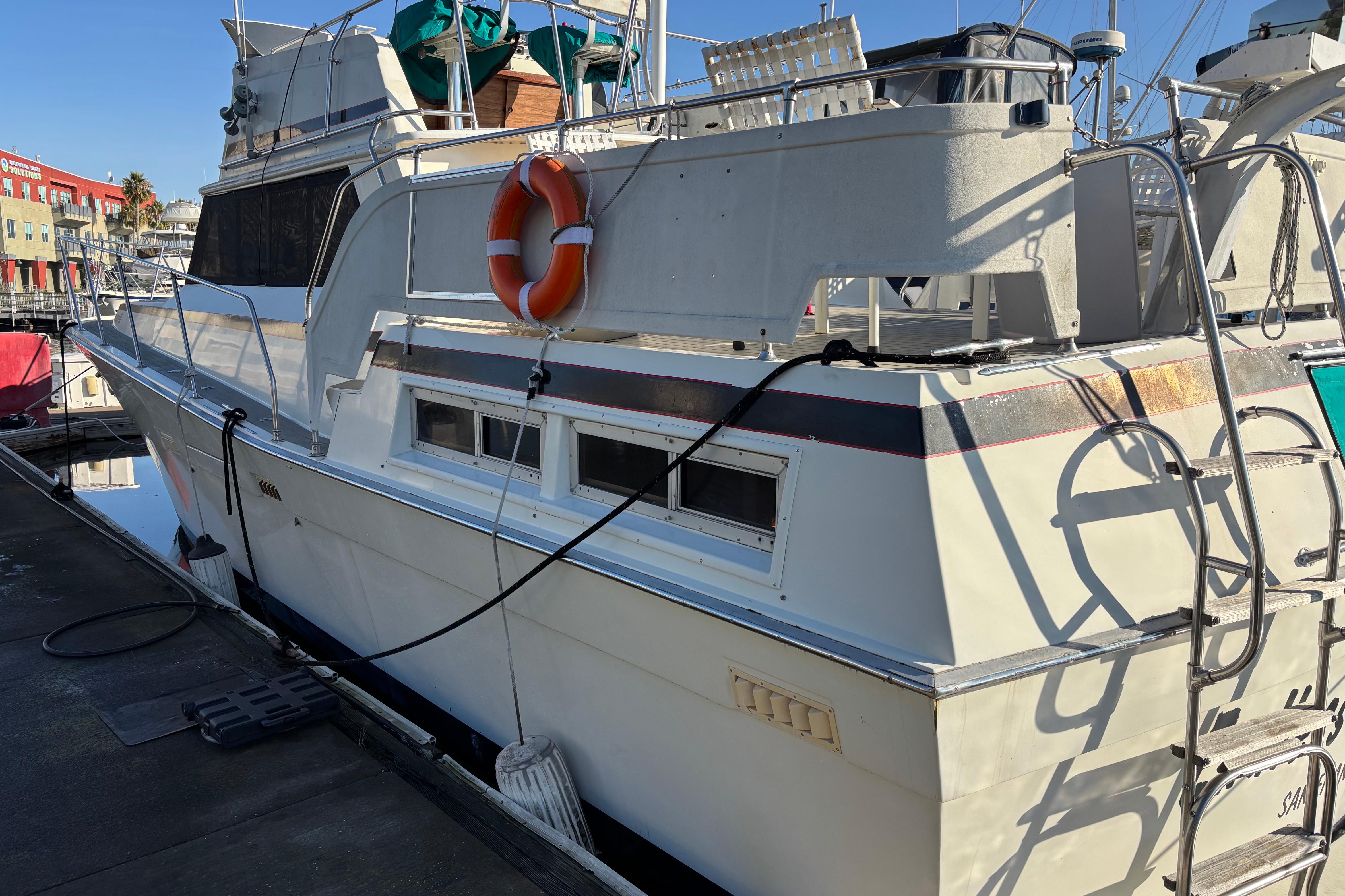 1979 Viking 43 yacht docked, featuring a life preserver and ladder on deck.