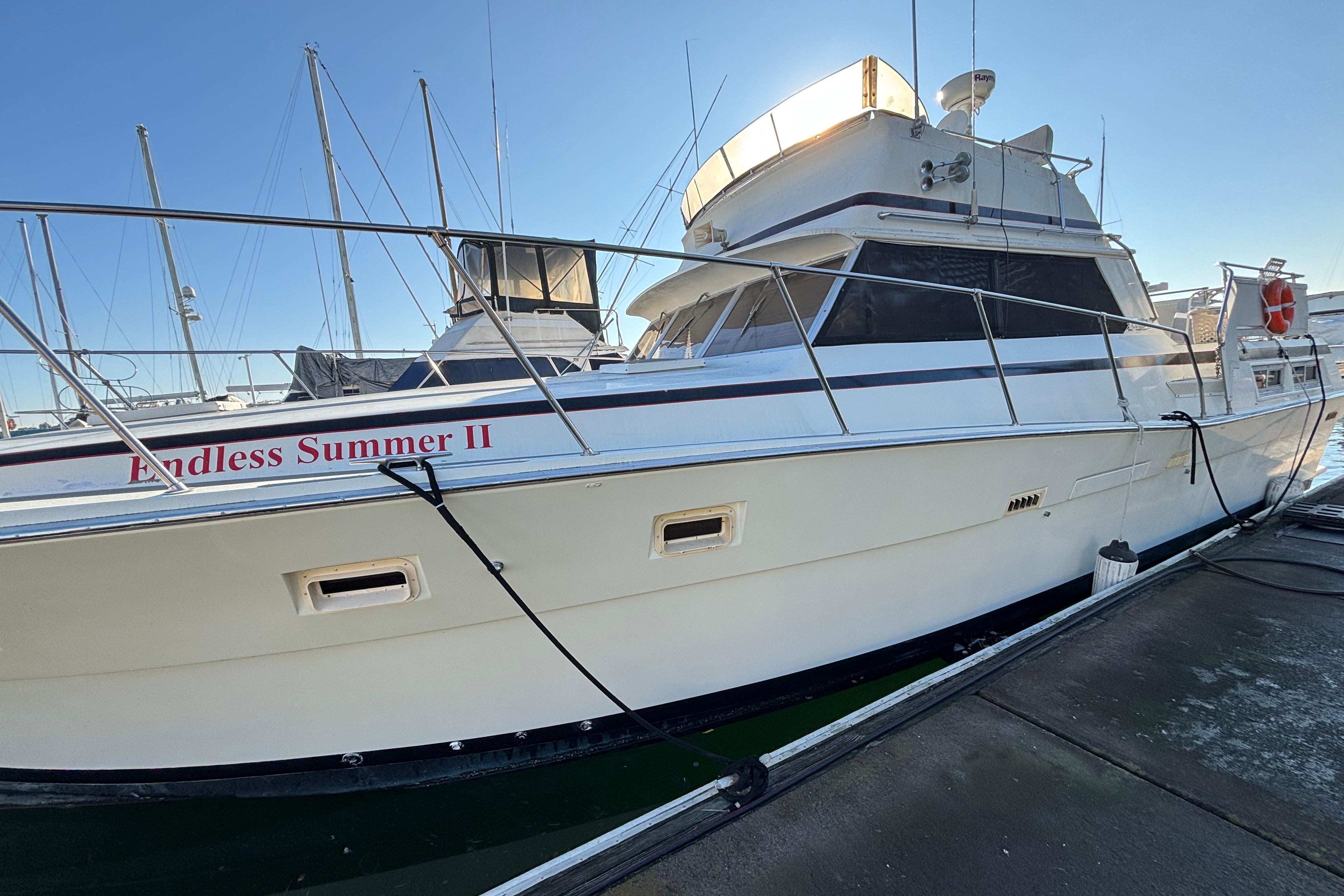 1979 Viking 43 yacht "Endless Summer II" docked at marina under clear blue sky.