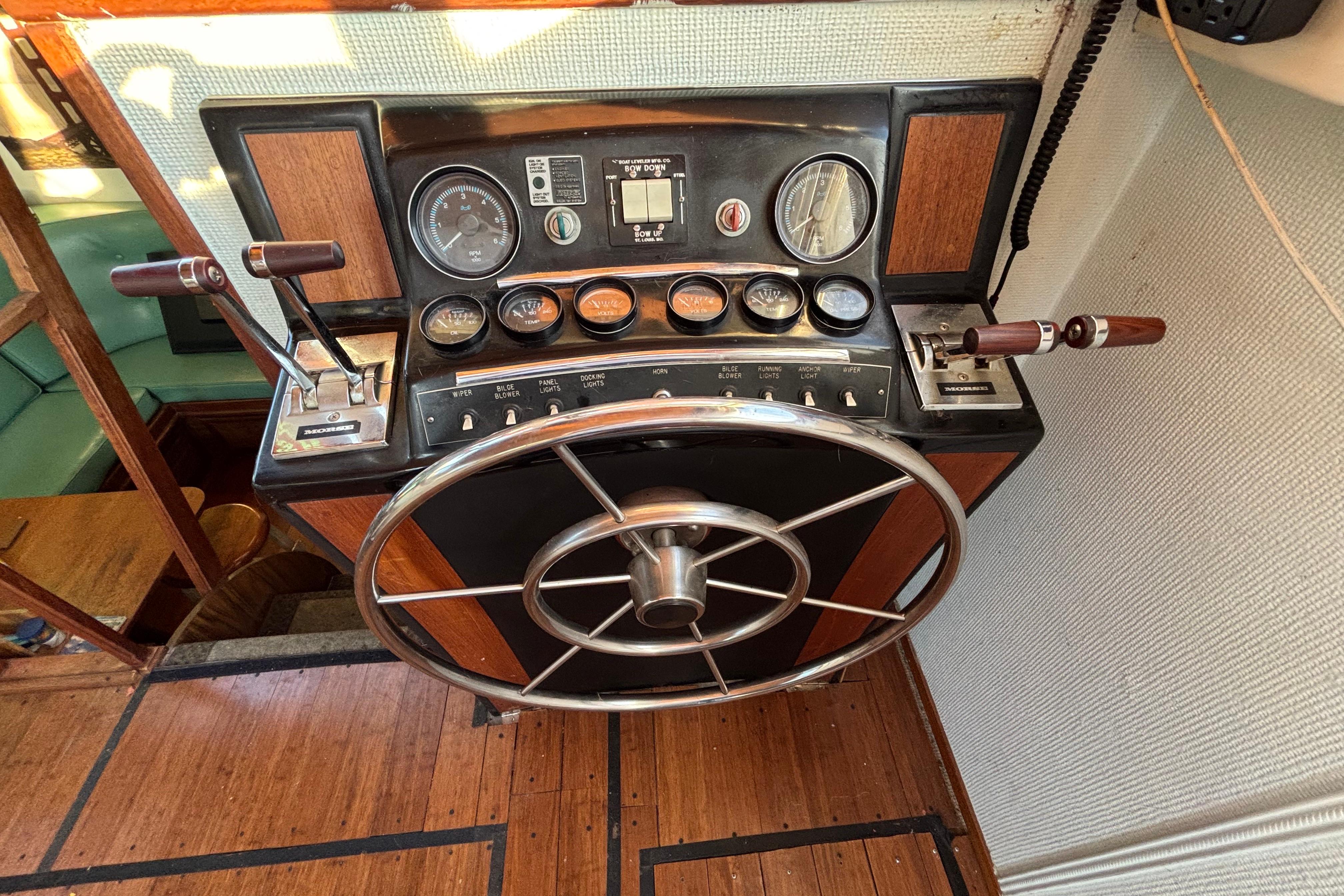 1979 Viking 43 boat helm with gauges, steering wheel, and control levers.