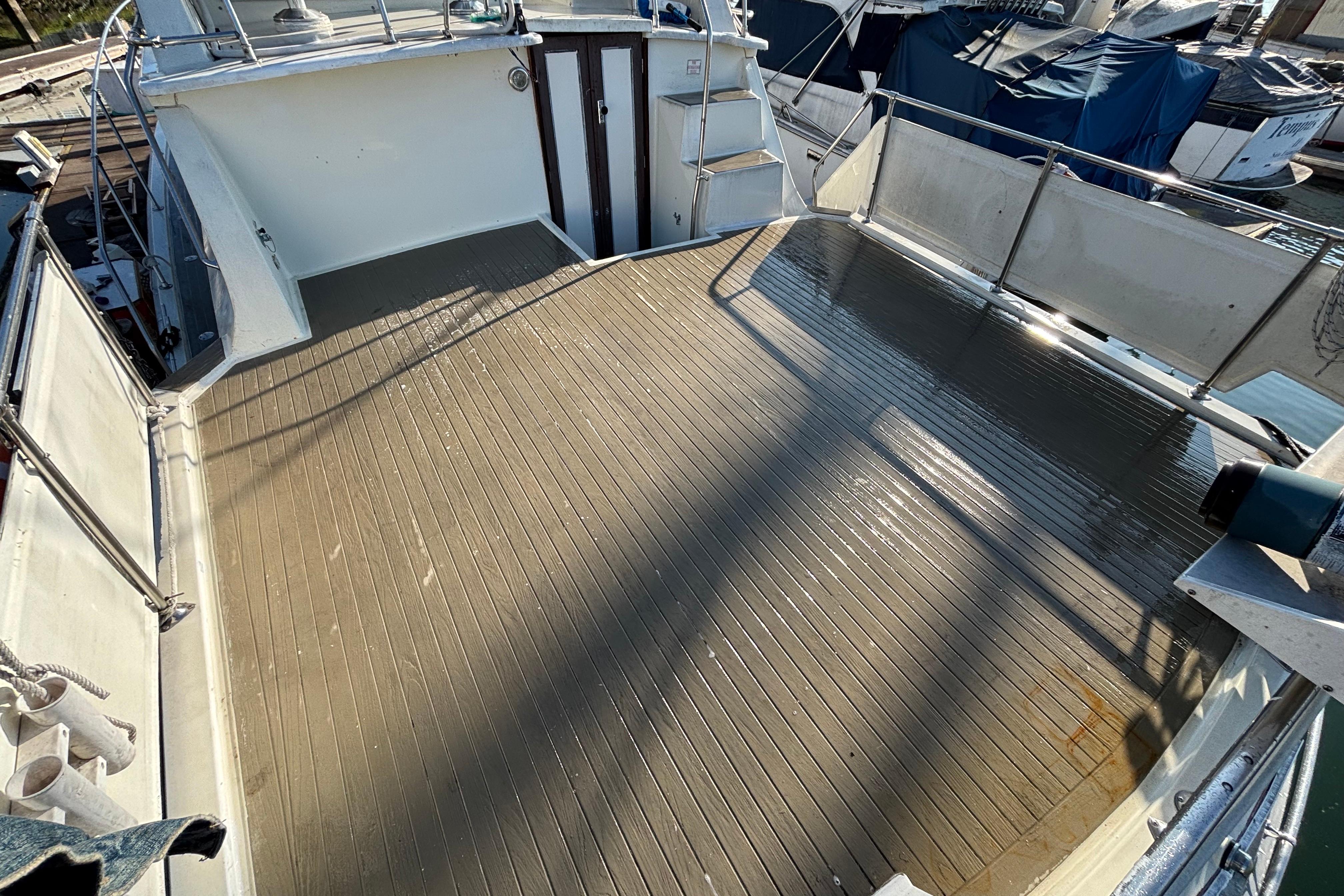 Spacious deck of a 1979 Viking 43 boat, featuring clean wooden flooring.