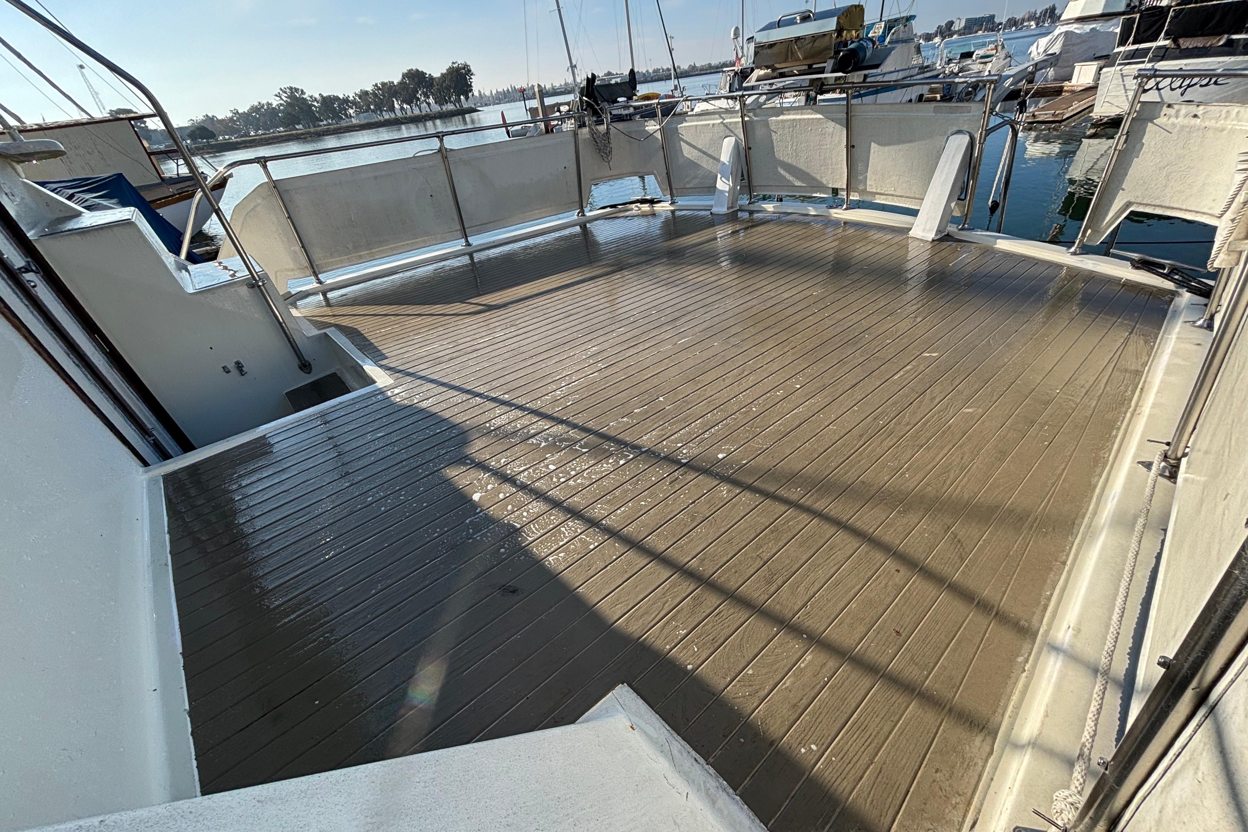 1979 Viking 43 yacht deck, spacious and sunlit, docked at marina.