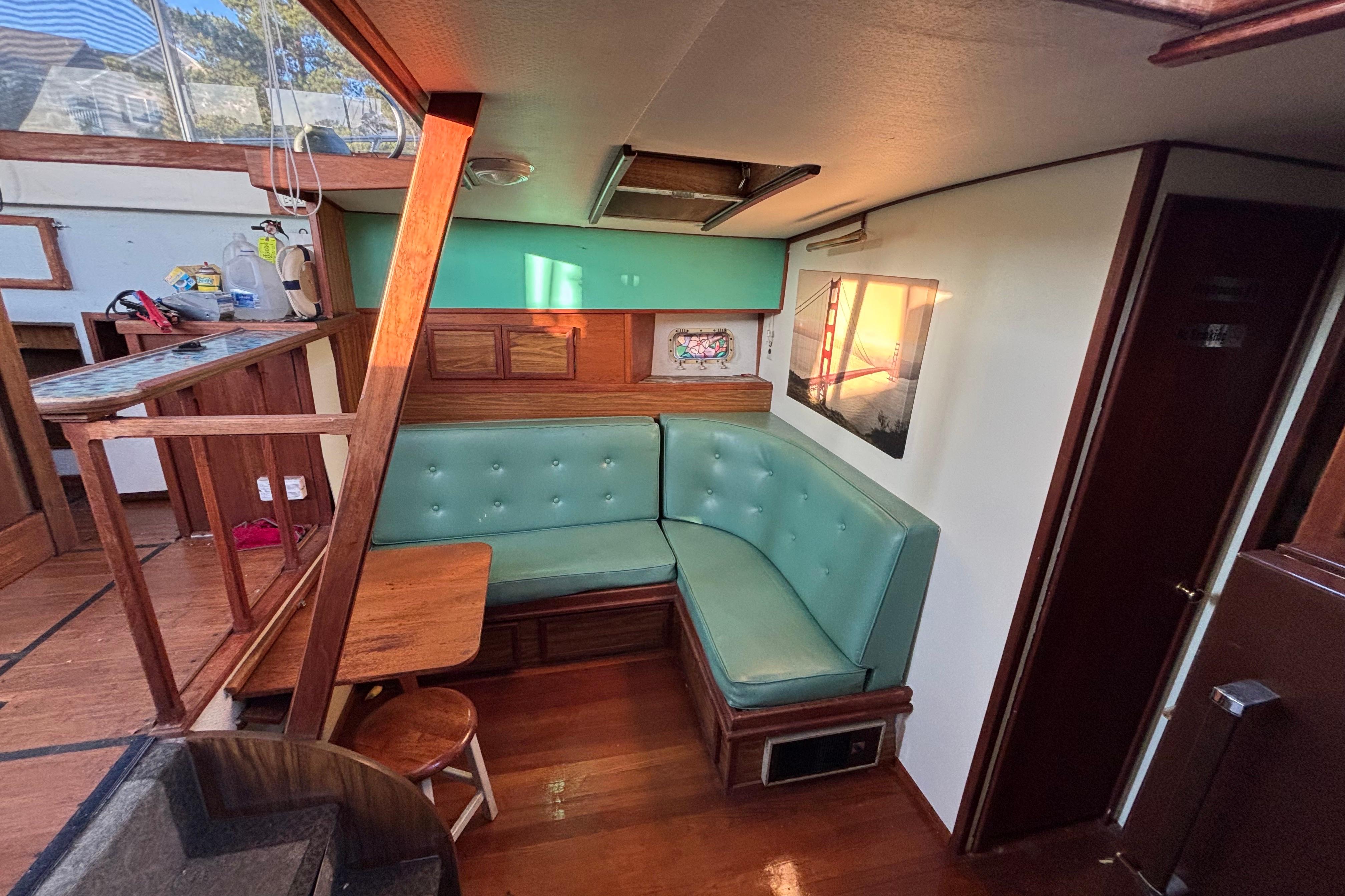 Interior of a 1979 Viking 43 boat with teal seating and wooden accents.