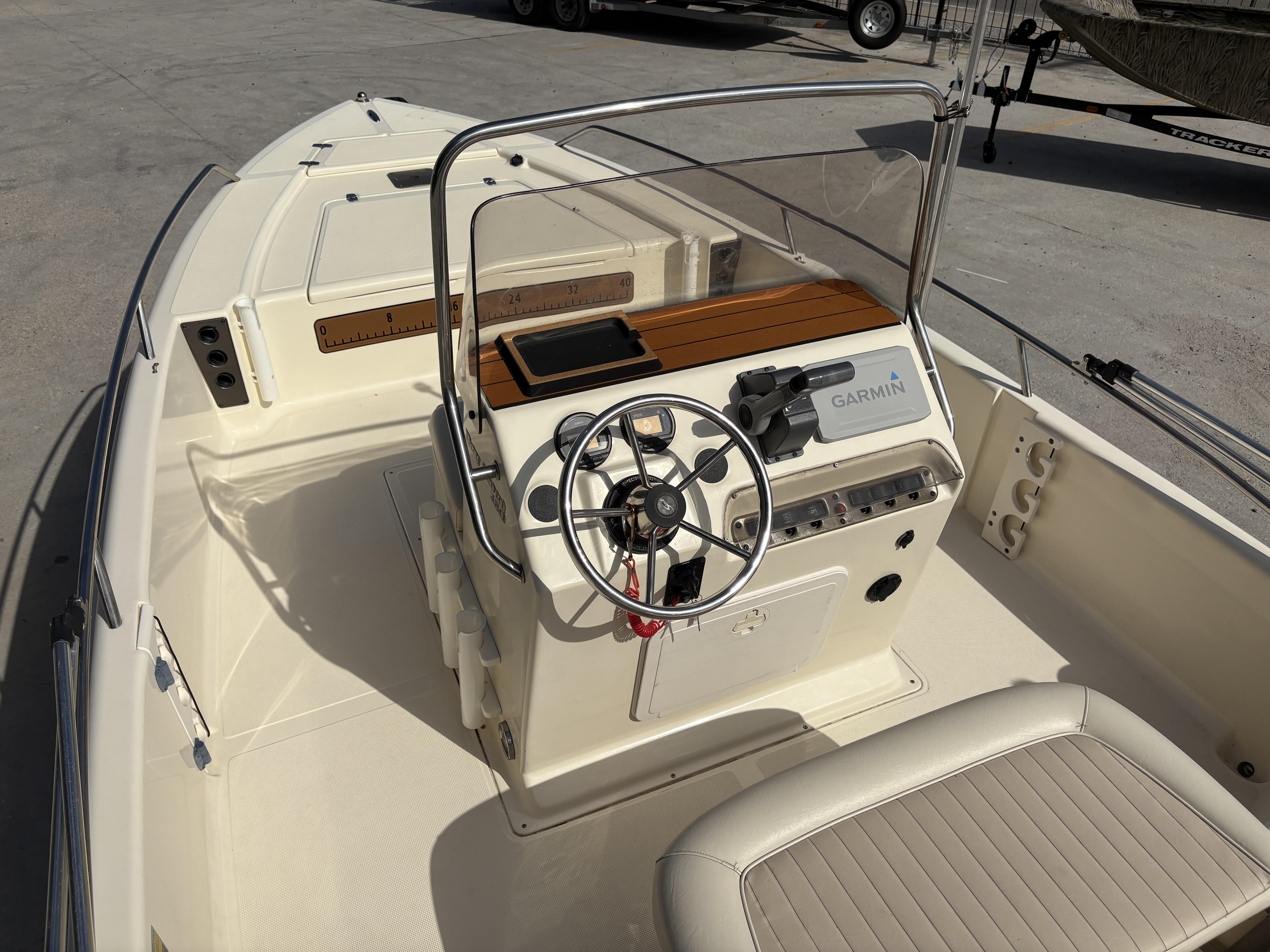 2005 Scout 17 boat interior with steering wheel and Garmin navigation system.