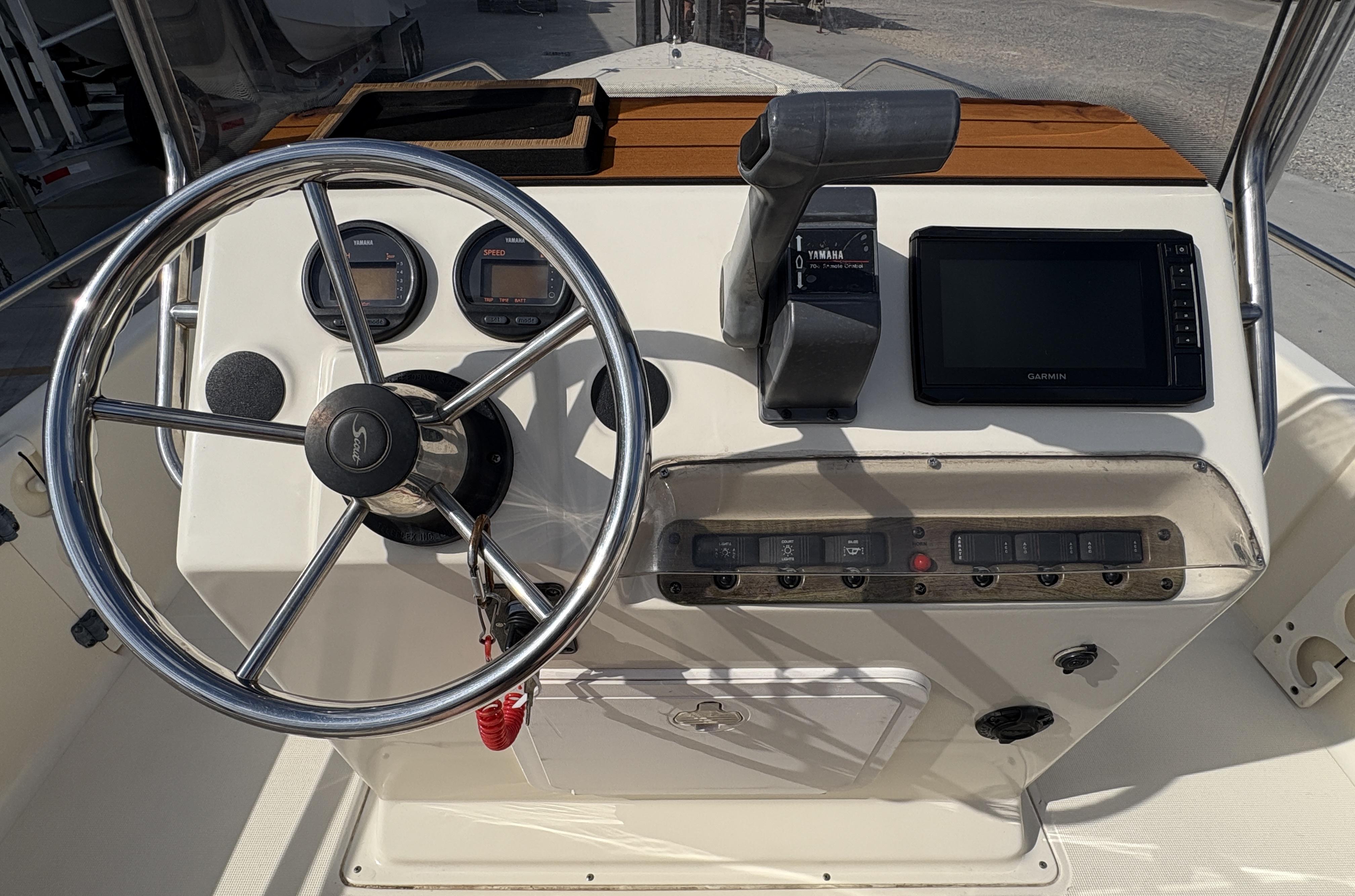 Steering console of a 2005 Scout 17 boat with gauges and controls.