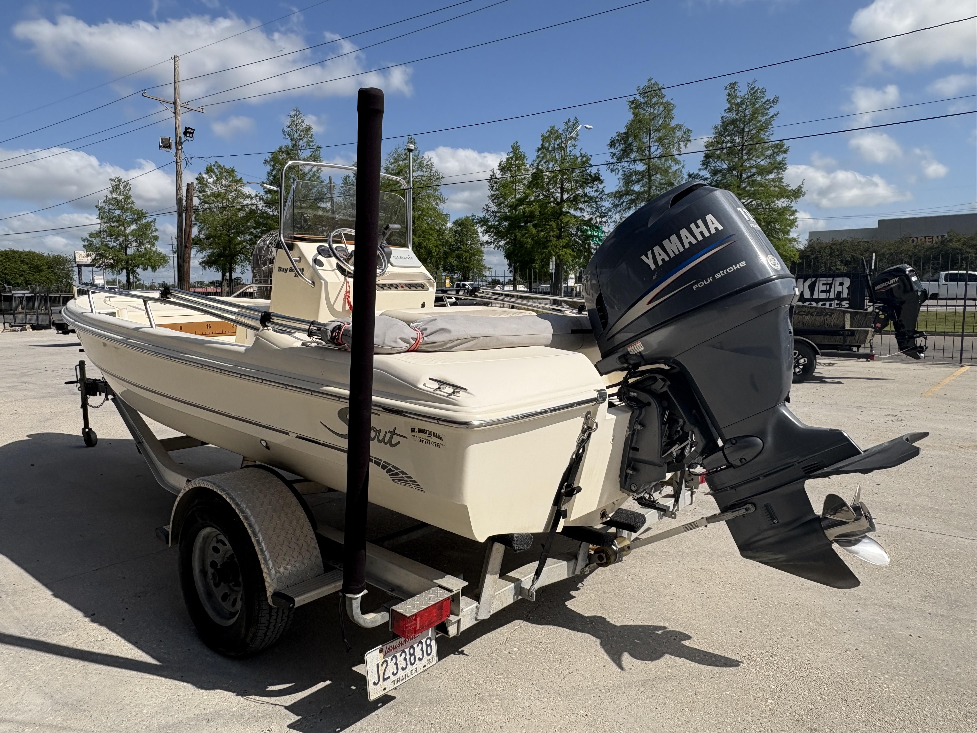 2005 Scout 17 boat with Yamaha outboard motor on trailer, parked outdoors.