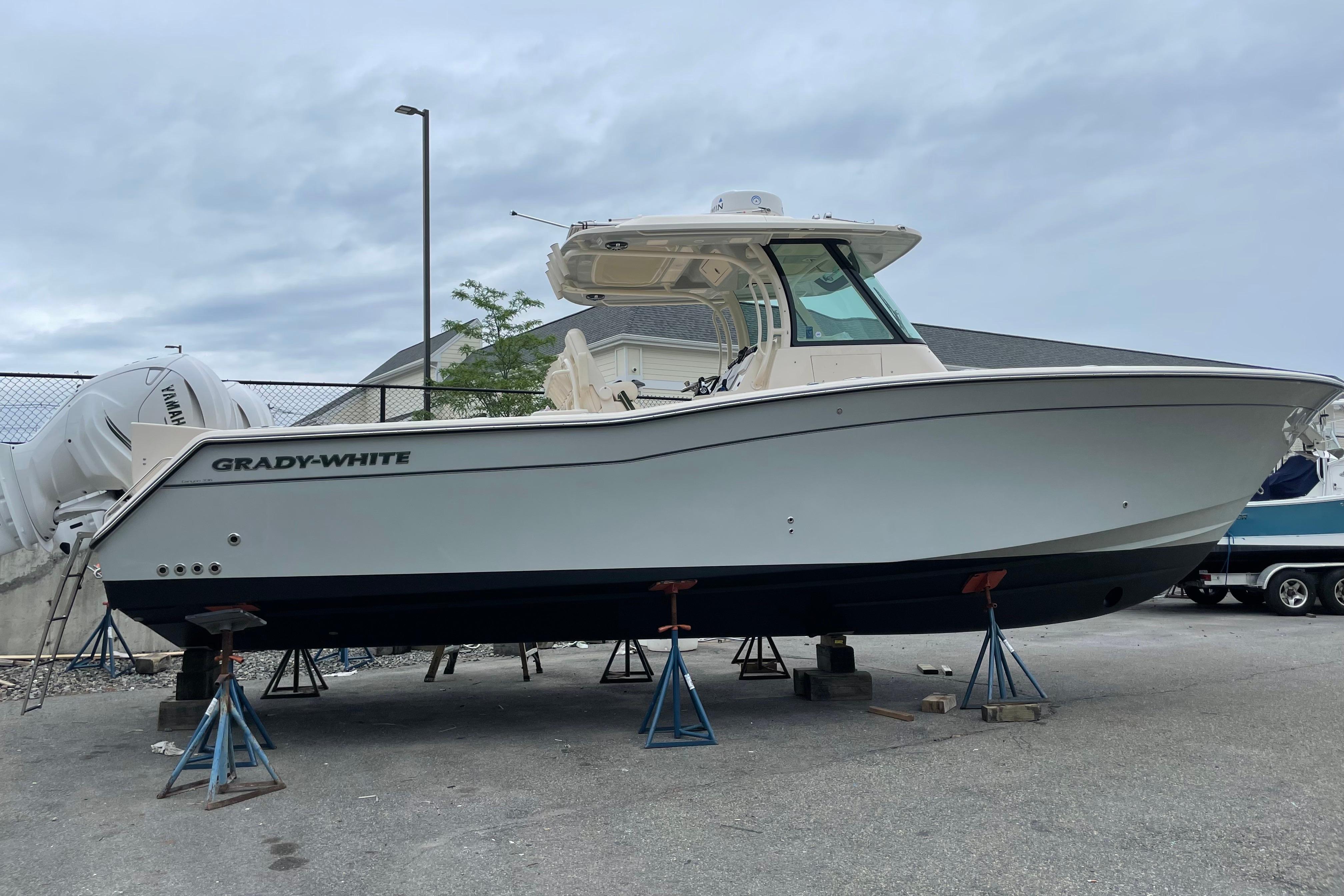 2020 Grady-White Canyon 336 boat on stands, side view, outdoors.