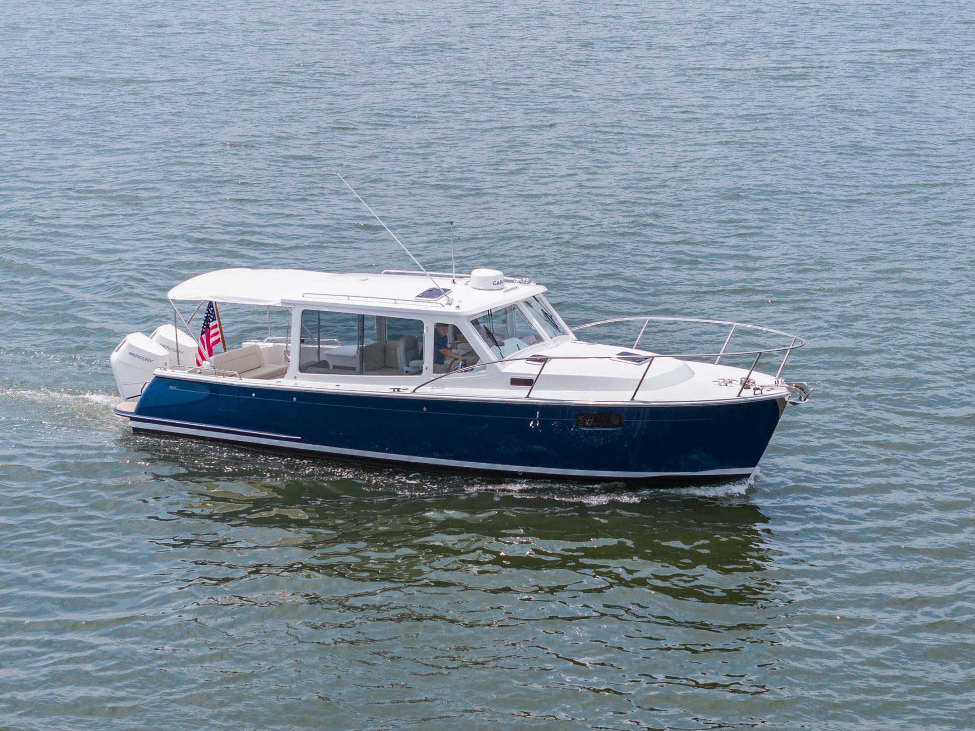 2025 MJM 35 boat cruising on water with American flag displayed.