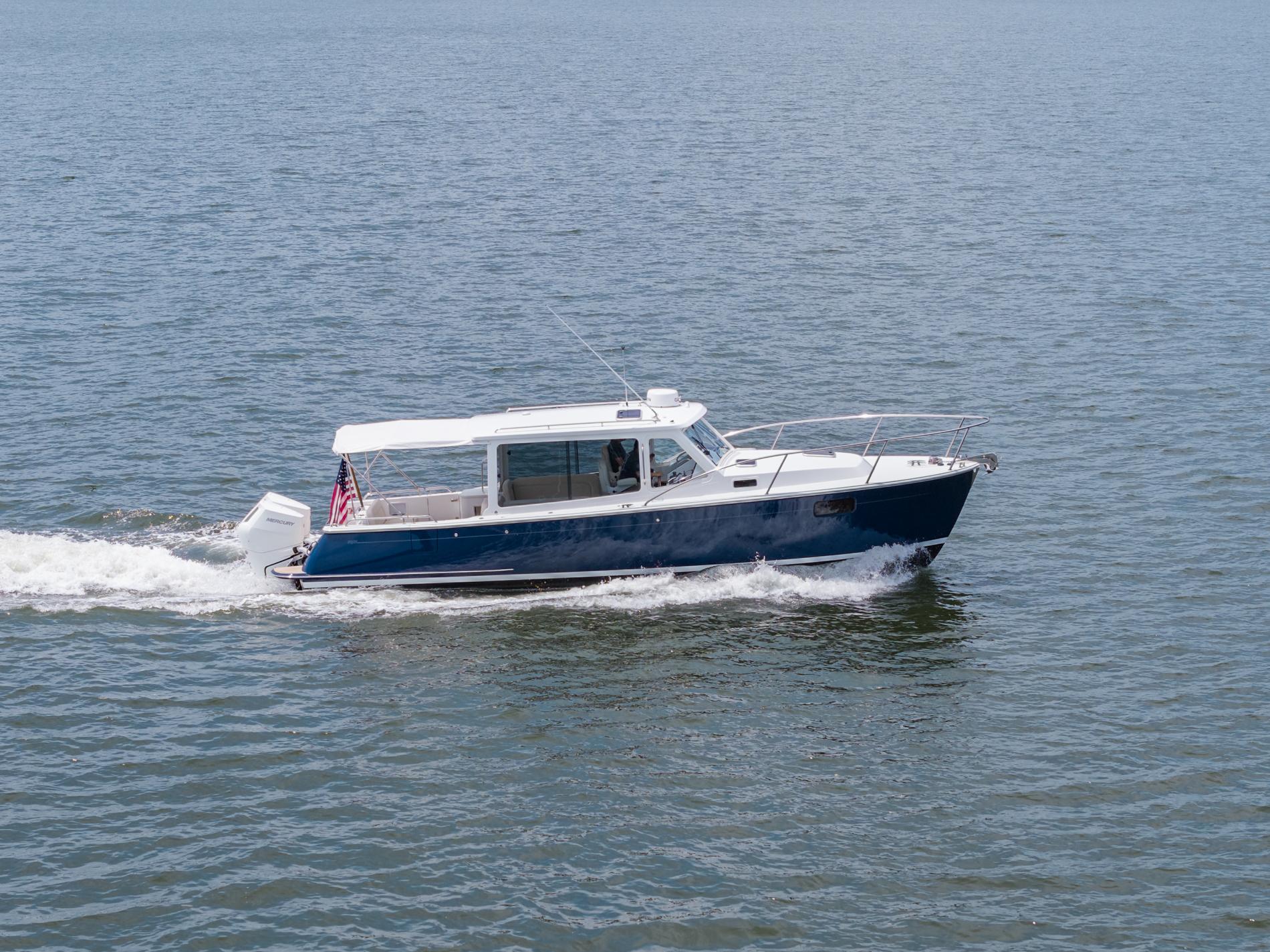2025 MJM 35 boat cruising on open water with American flag.