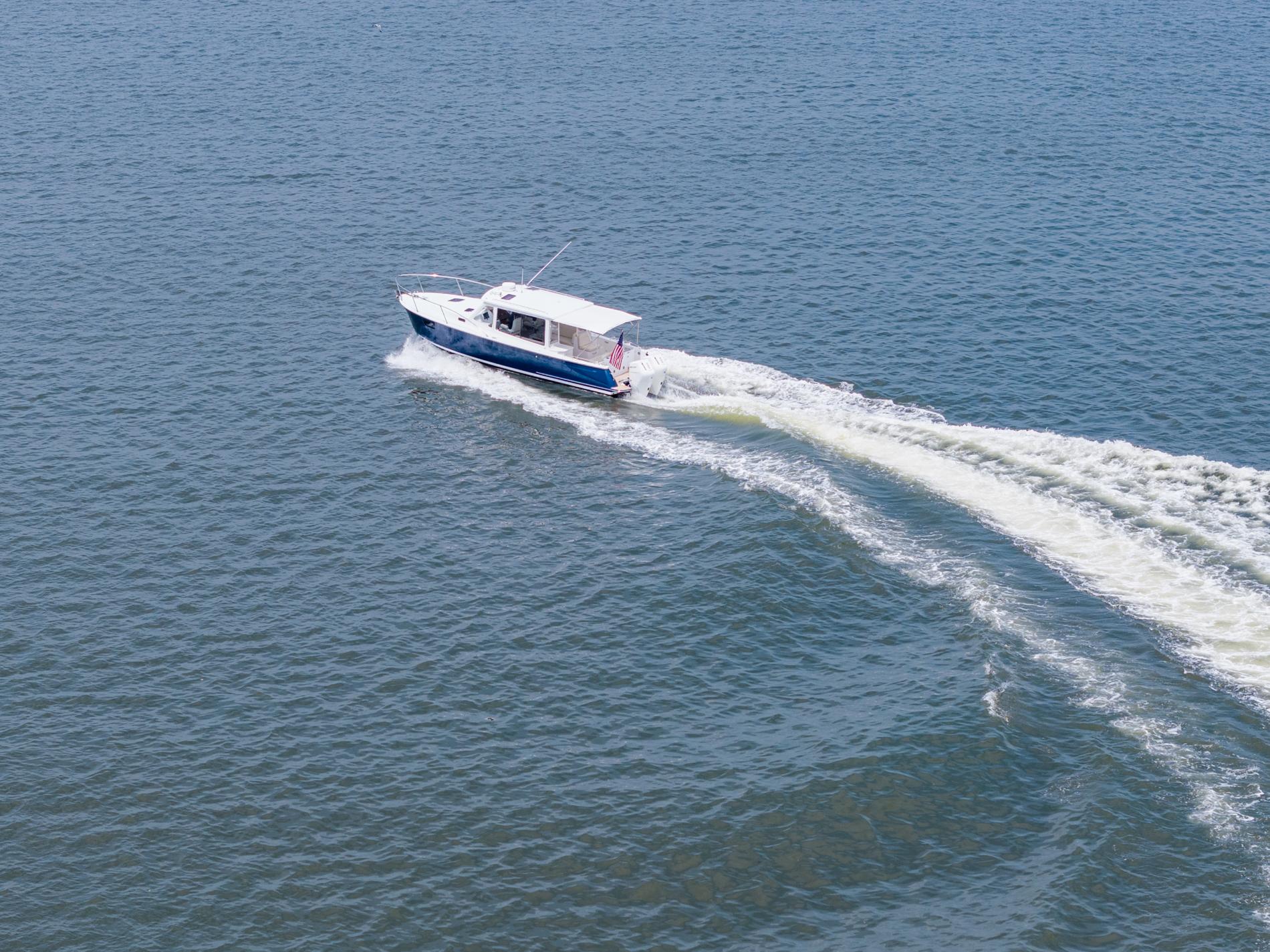 2025 MJM 35 boat cruising on open water, leaving a wake behind.