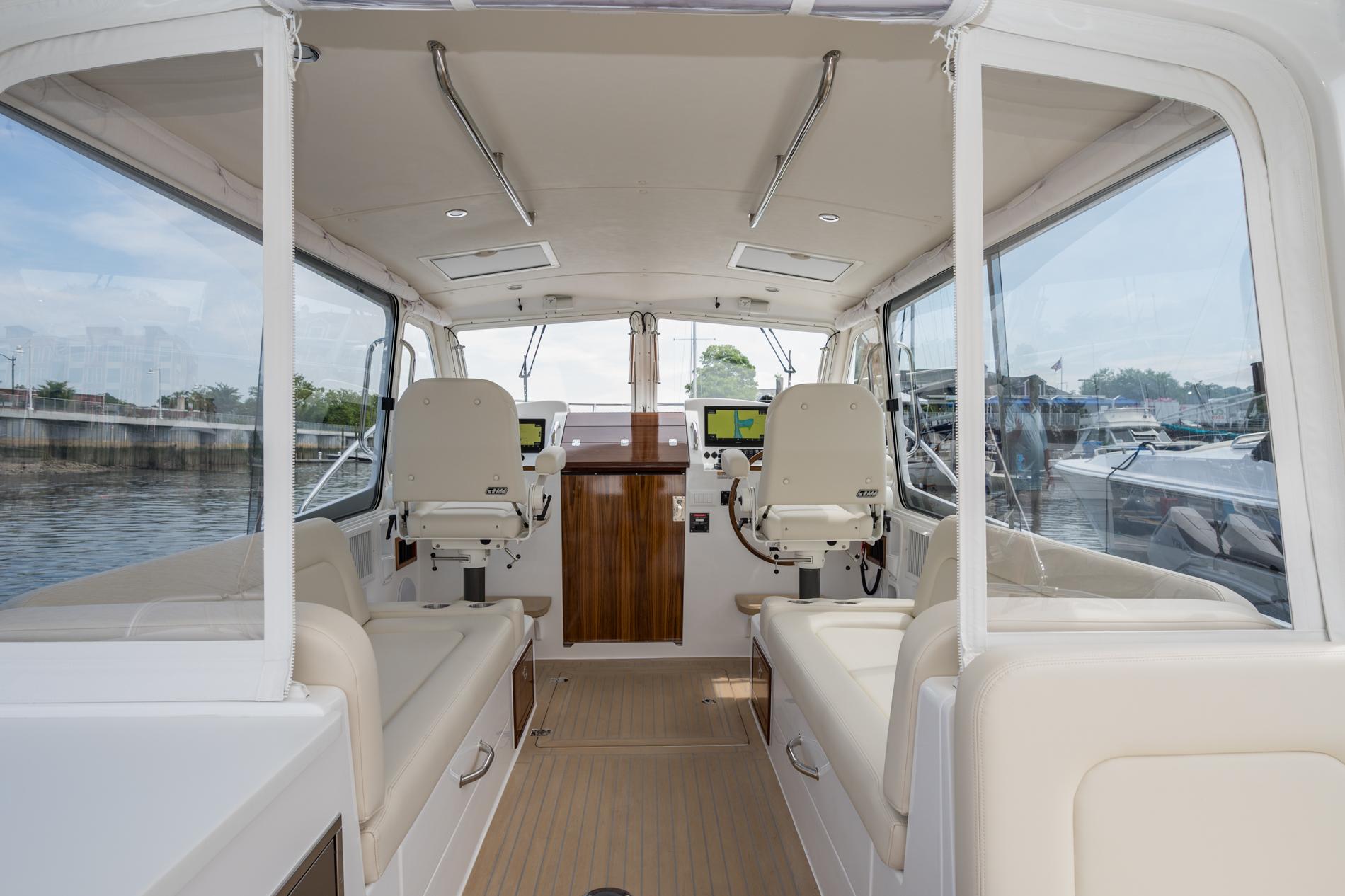 Interior of 2025 MJM 35 boat with modern seating and navigation equipment.