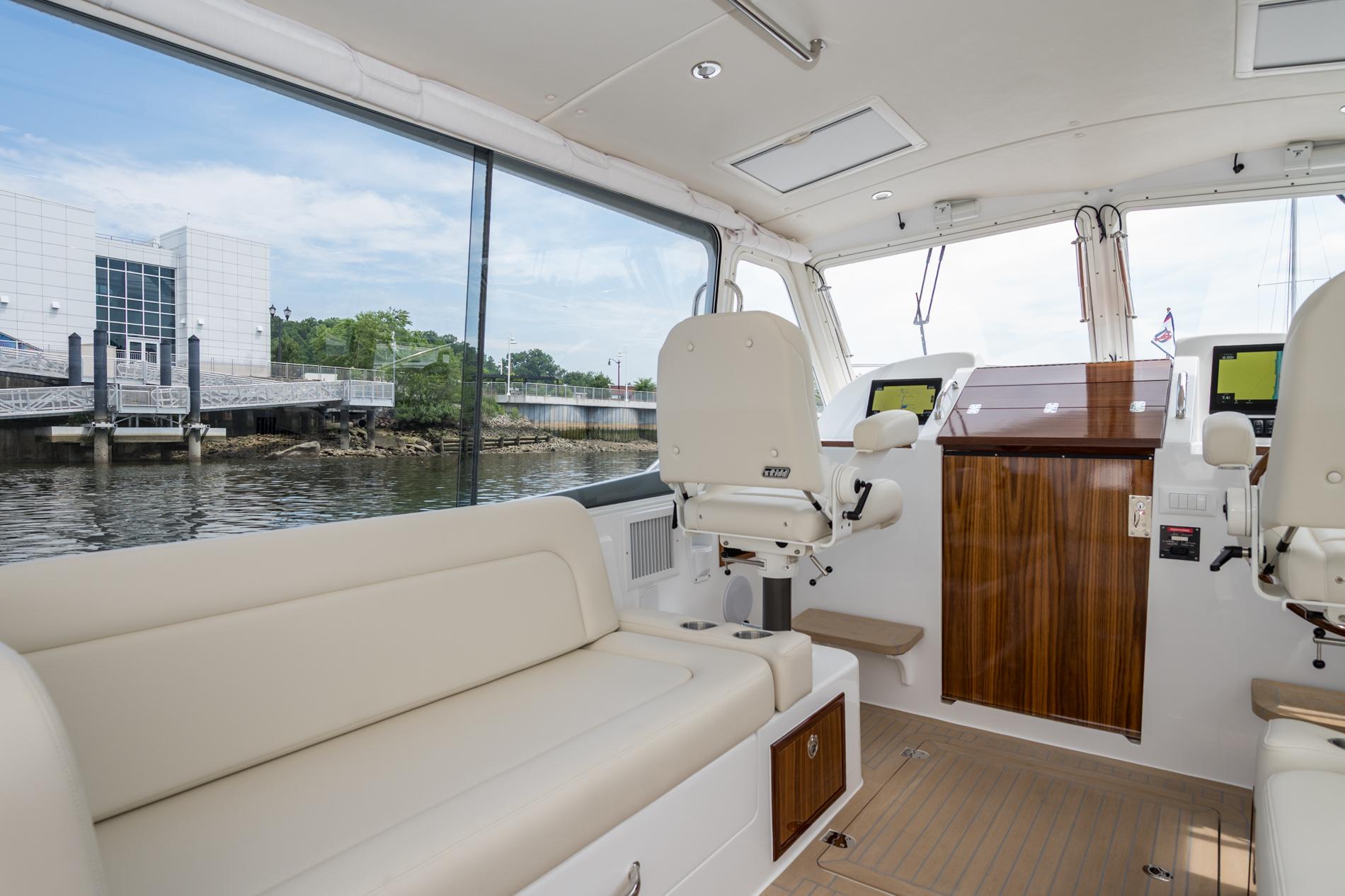 Interior of 2025 MJM 35 boat with modern seating and navigation equipment.
