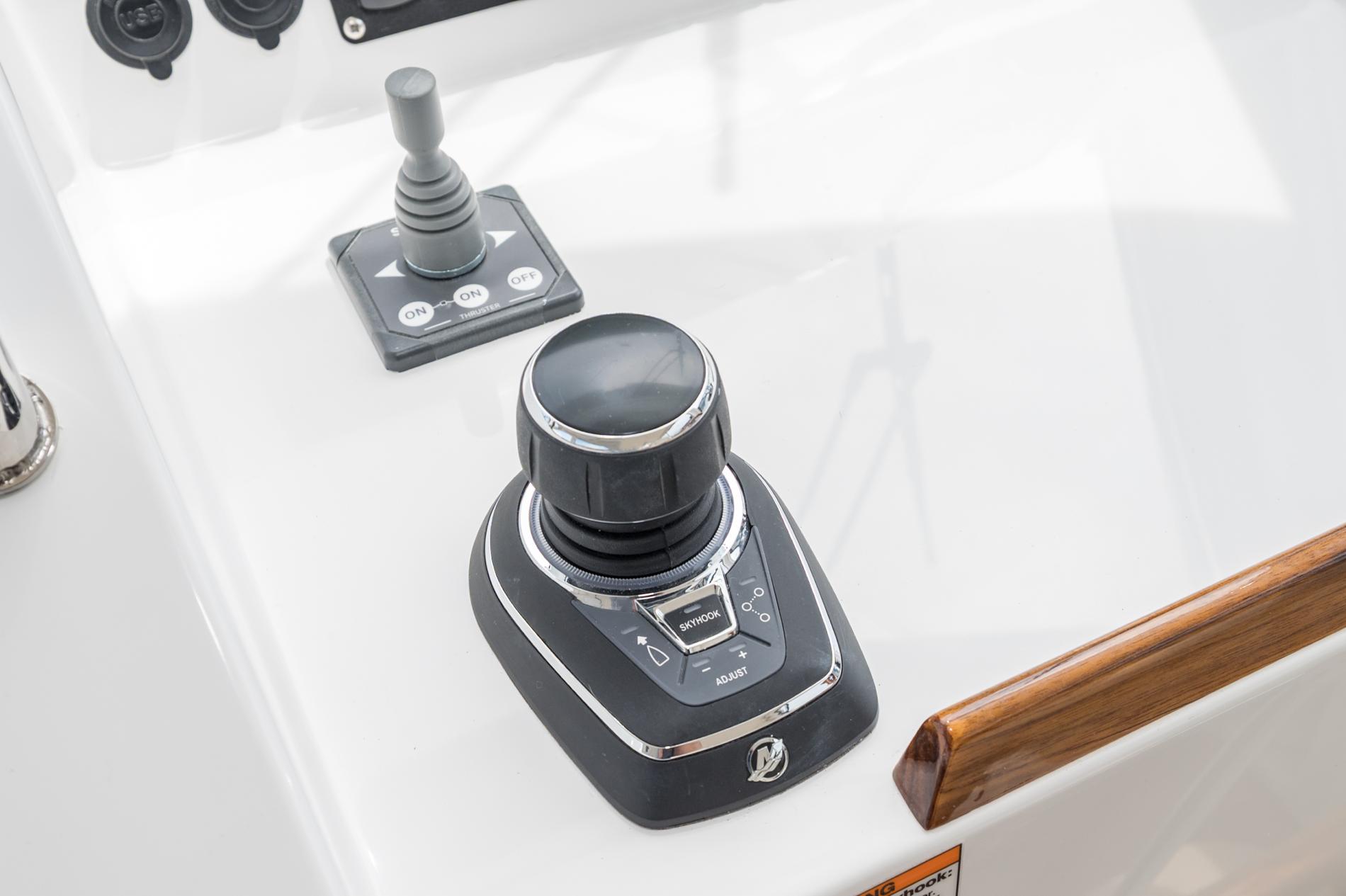 Control panel of 2025 MJM 35 boat featuring joystick and throttle controls.