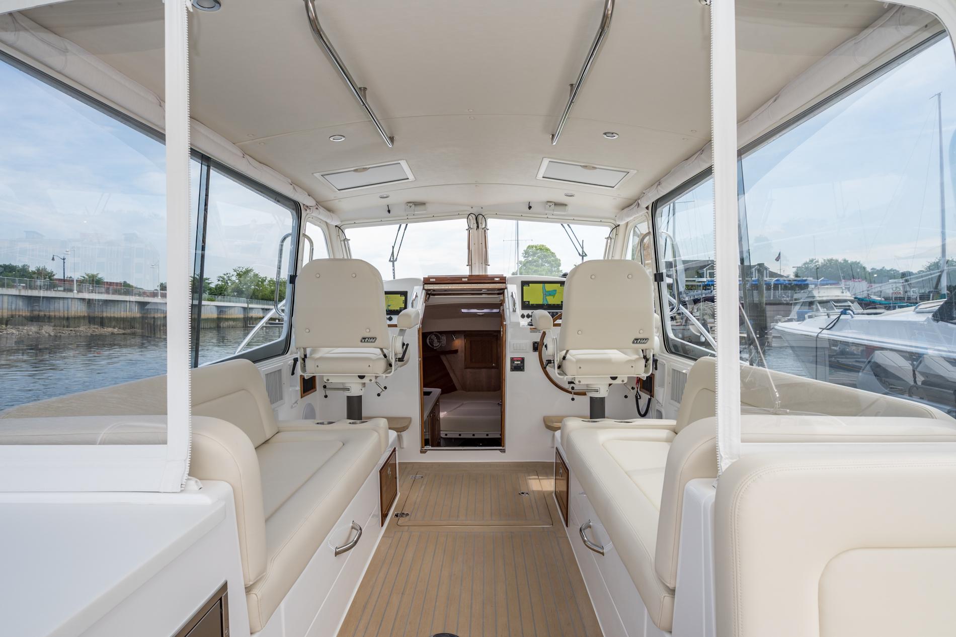 Interior of 2025 MJM 35 boat with modern seating and navigation equipment.