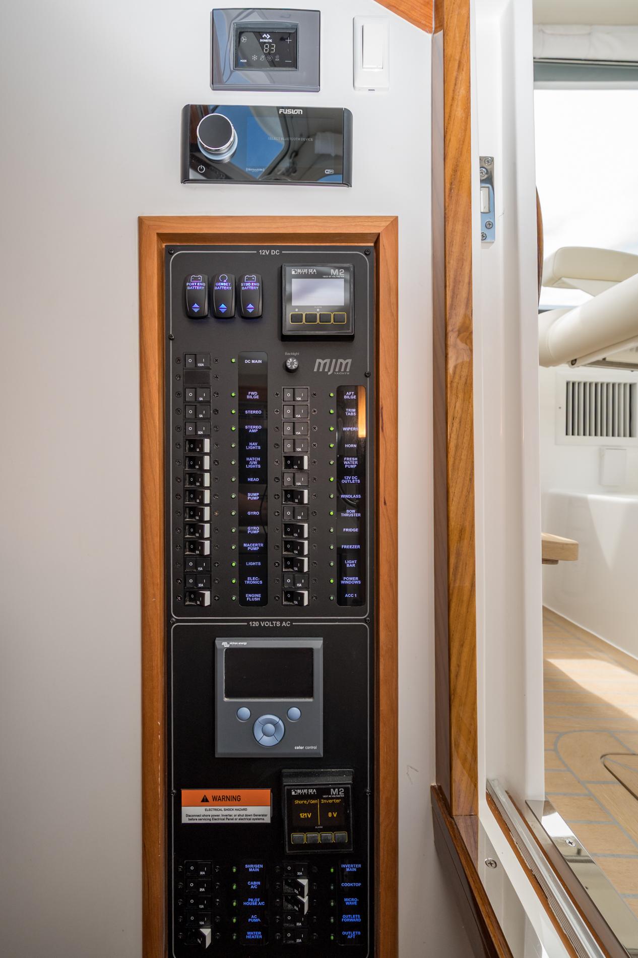 Electrical control panel on 2025 MJM 35 boat, featuring switches and displays.