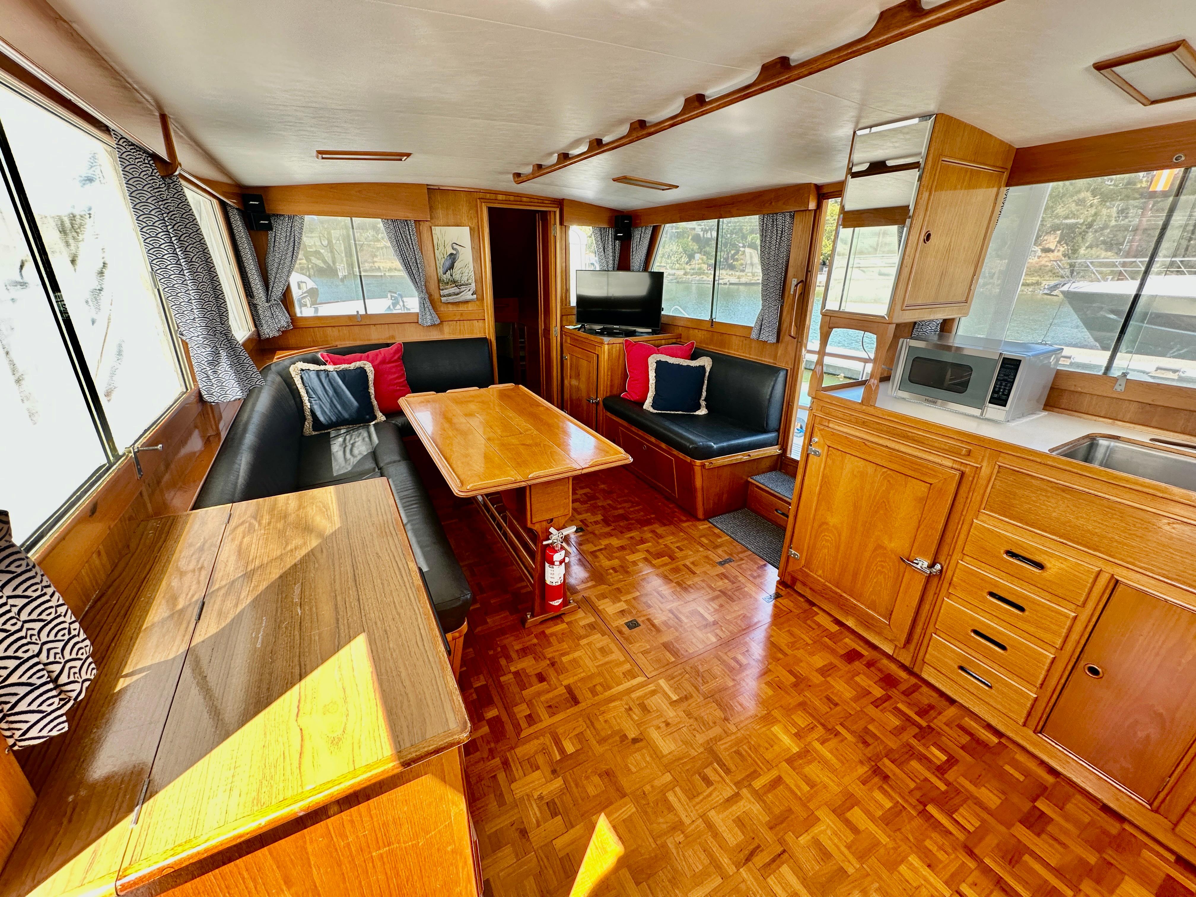 Interior of 1989 Grand Banks 42 Classic yacht with wood finish and cozy seating area.