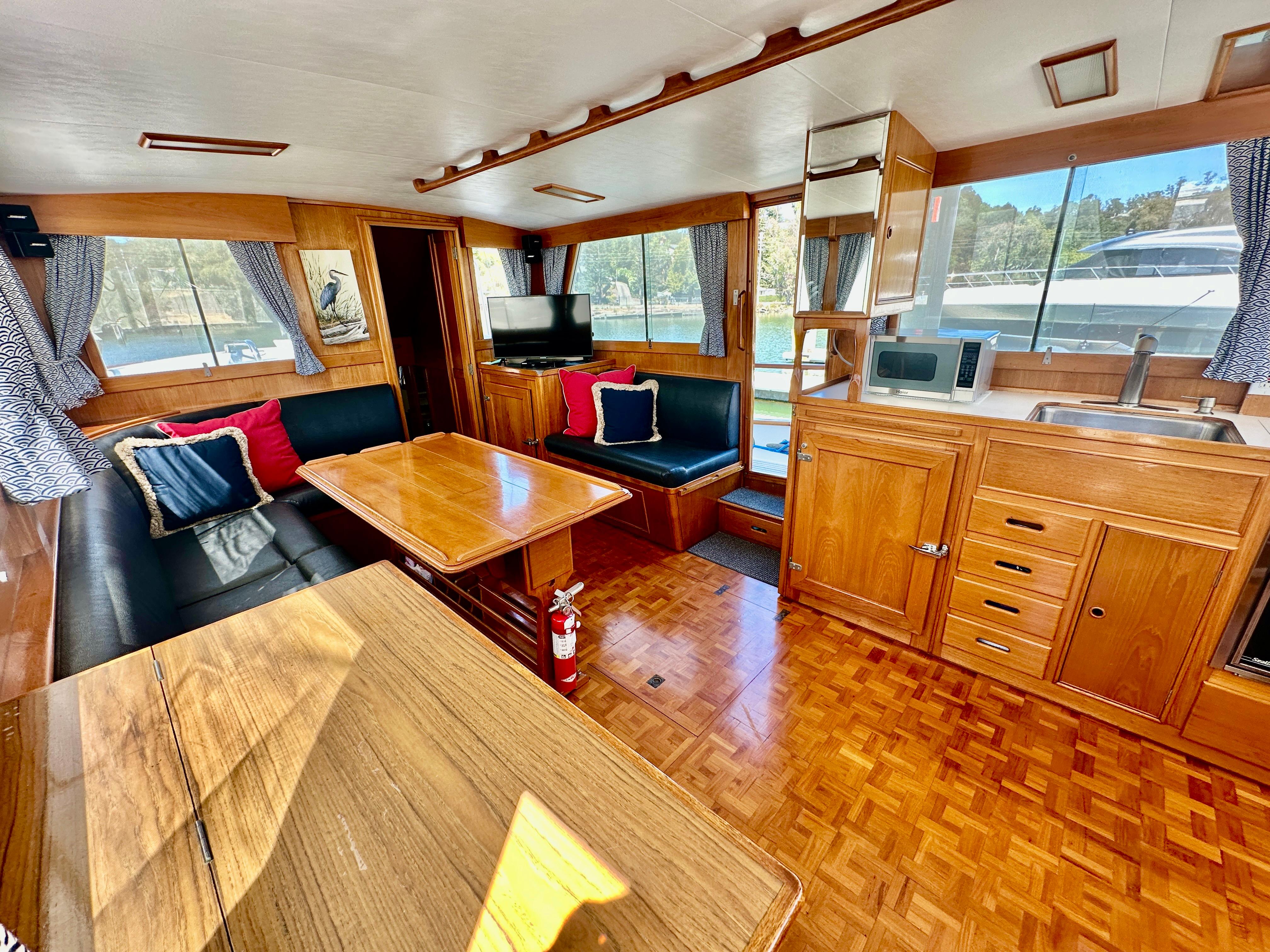 Interior of 1989 Grand Banks 42 Classic yacht with wood finish and cozy seating area.