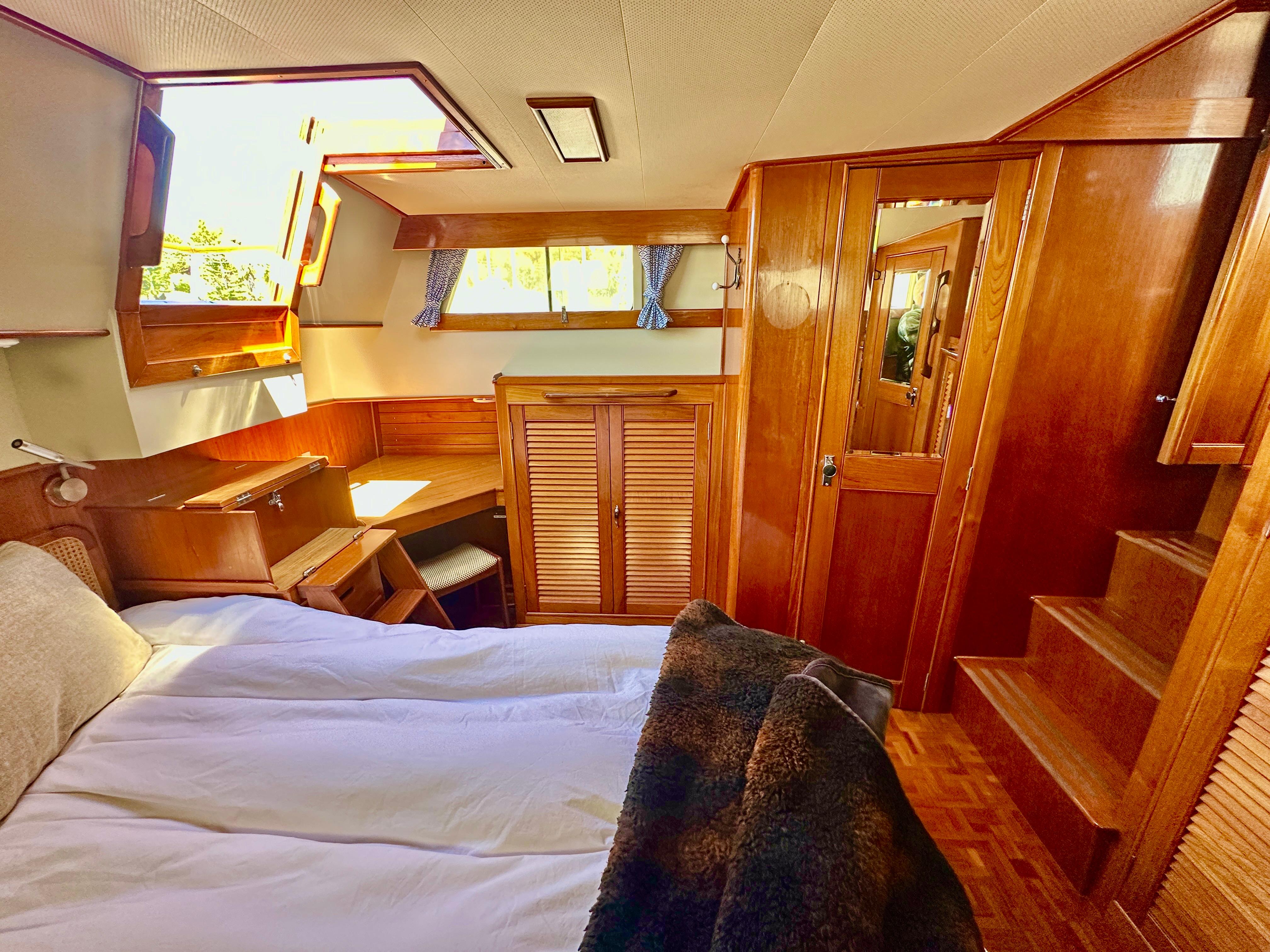 Cozy cabin interior of 1989 Grand Banks 42 Classic with wooden furnishings and natural light.