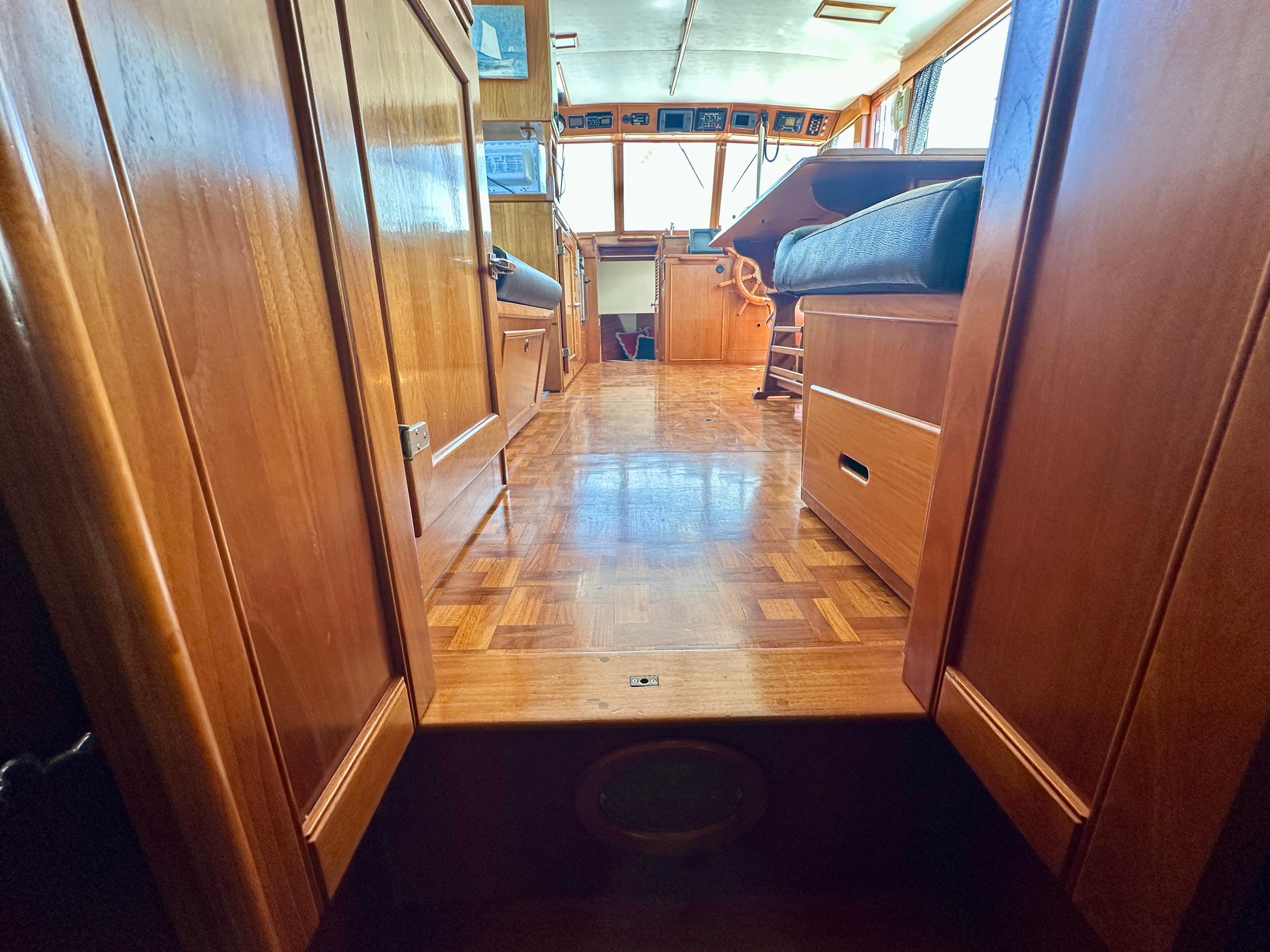 Interior view of 1989 Grand Banks 42 Classic yacht with wooden flooring and seating.