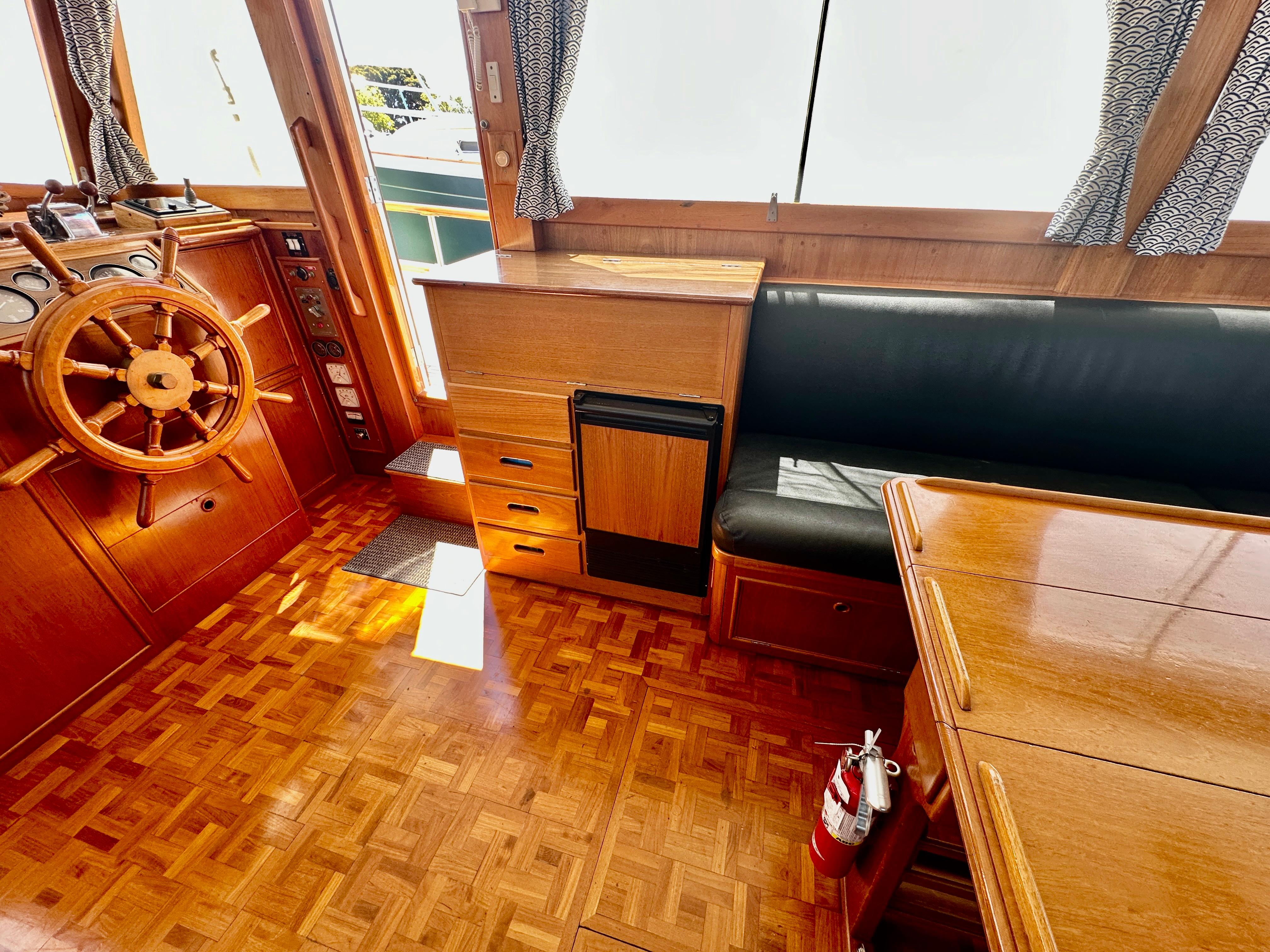 Interior of 1989 Grand Banks 42 Classic yacht with wooden helm and seating area.