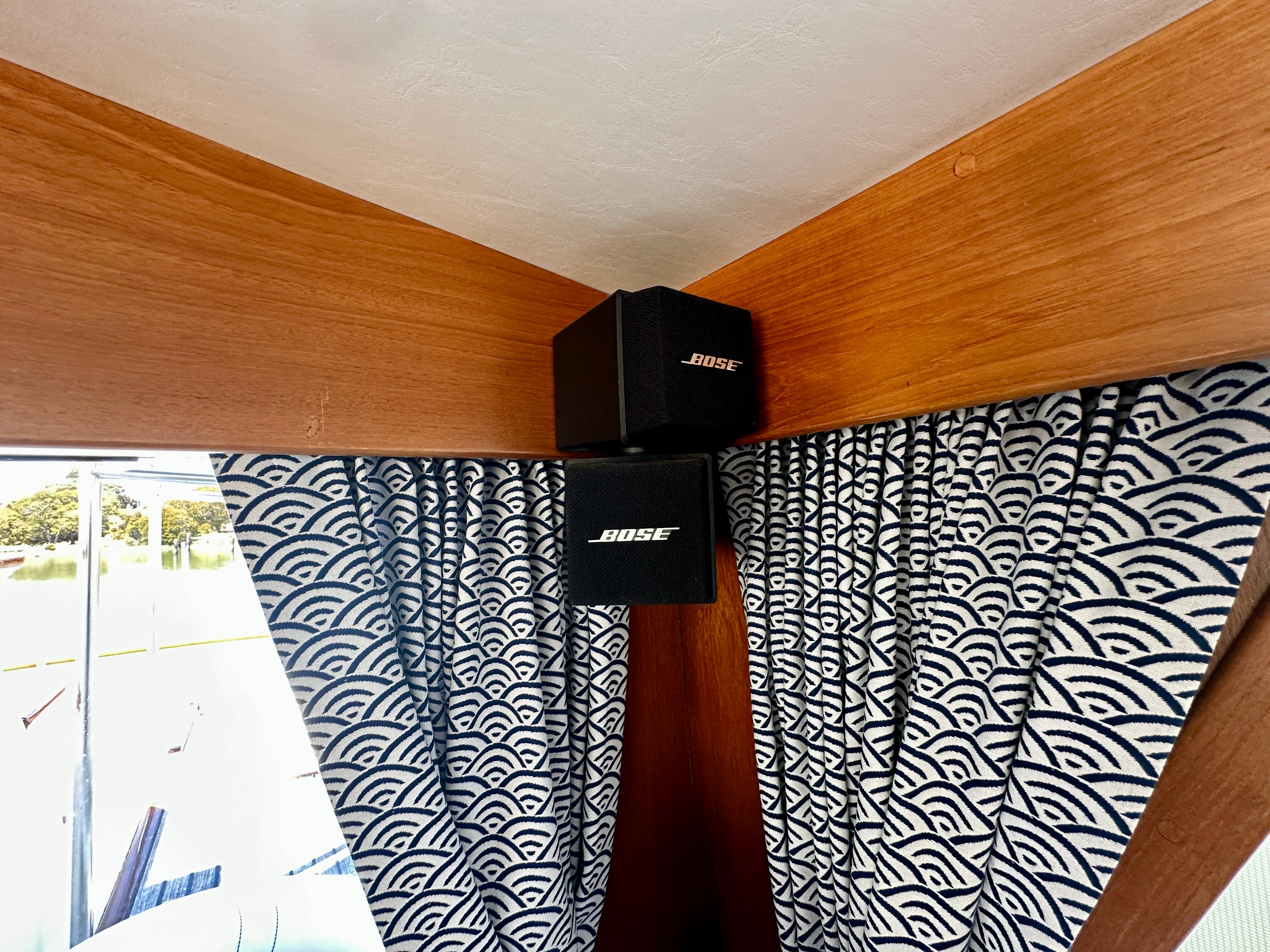 Bose speakers on a 1989 Grand Banks 42 Classic with patterned curtains.