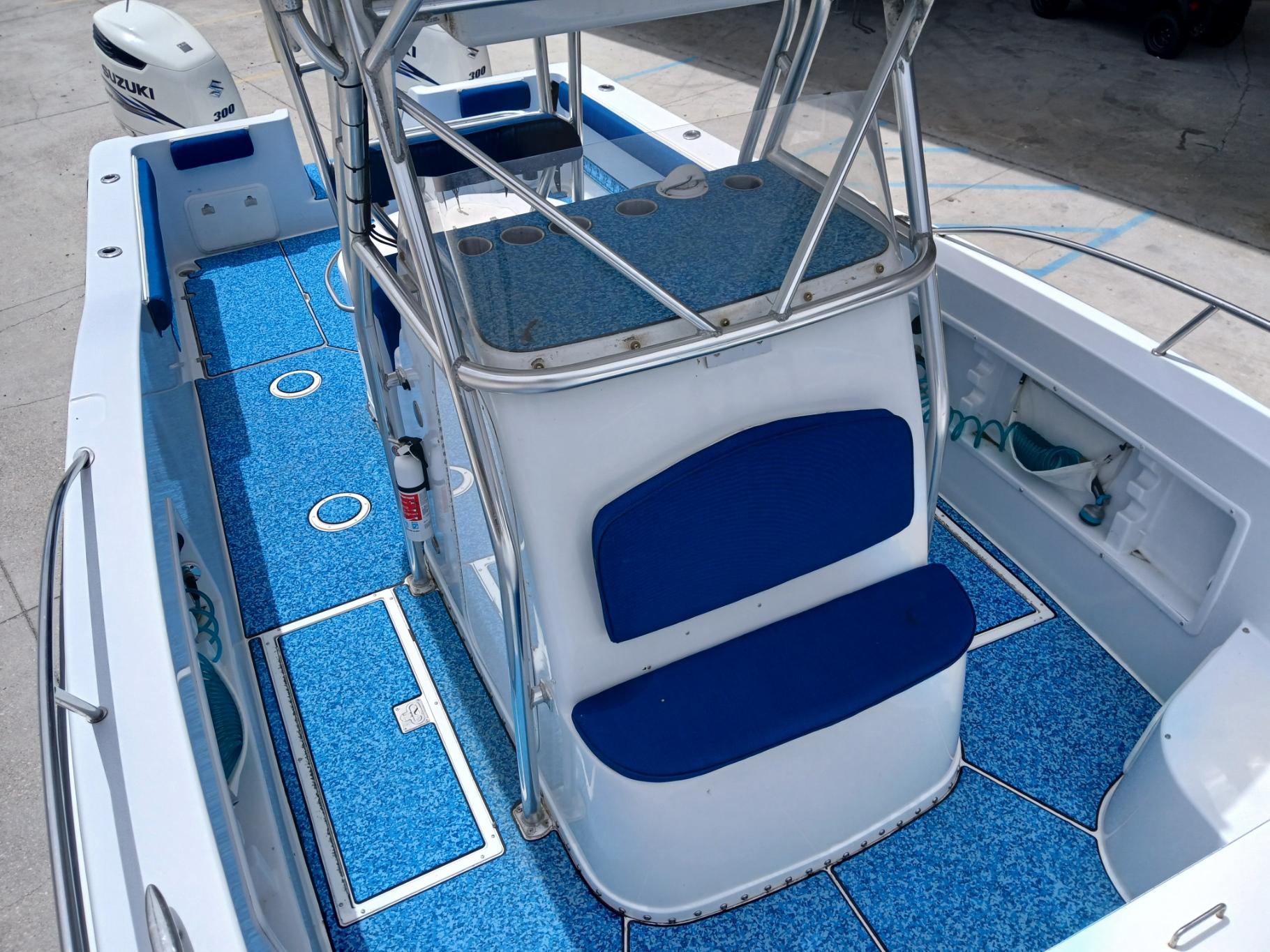 2002 ProKat 2860 Center Console boat with blue deck and seating.