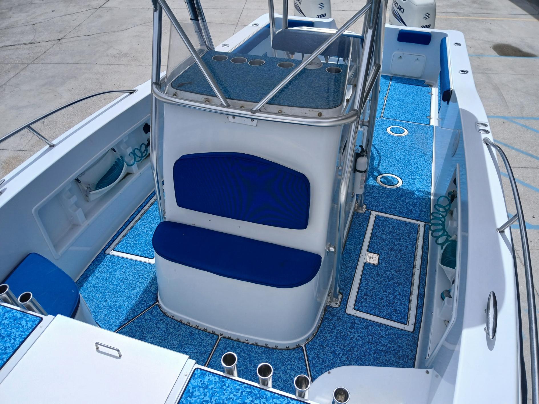 2002 ProKat 2860 Center Console boat interior with blue seating and deck.