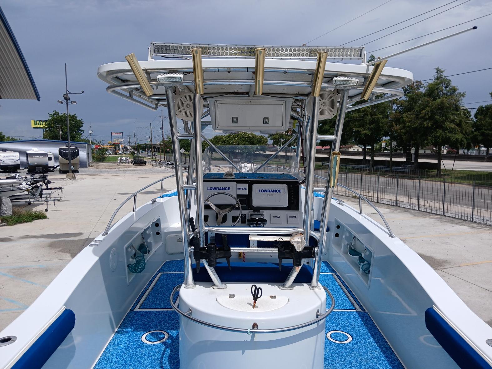 2002 ProKat 2860 Center Console boat with blue deck, equipped with Lowrance electronics.